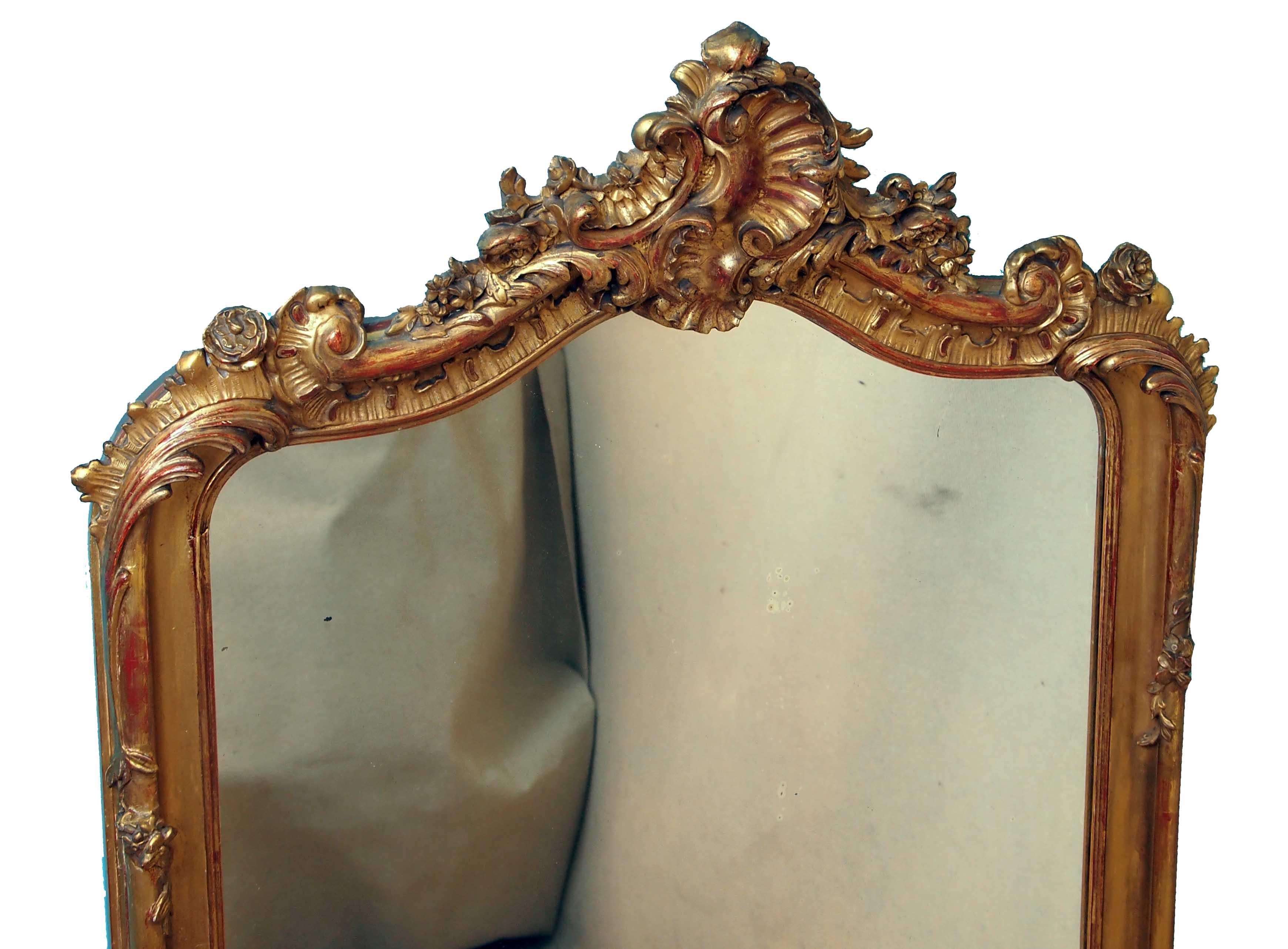 An attractive late 19th century gilt overmantle mirror of good
proportion having superbly carved top above original mirror
plate flanked by half turned columns with foliate
carved decoration

(This mirror is significantly better quality than