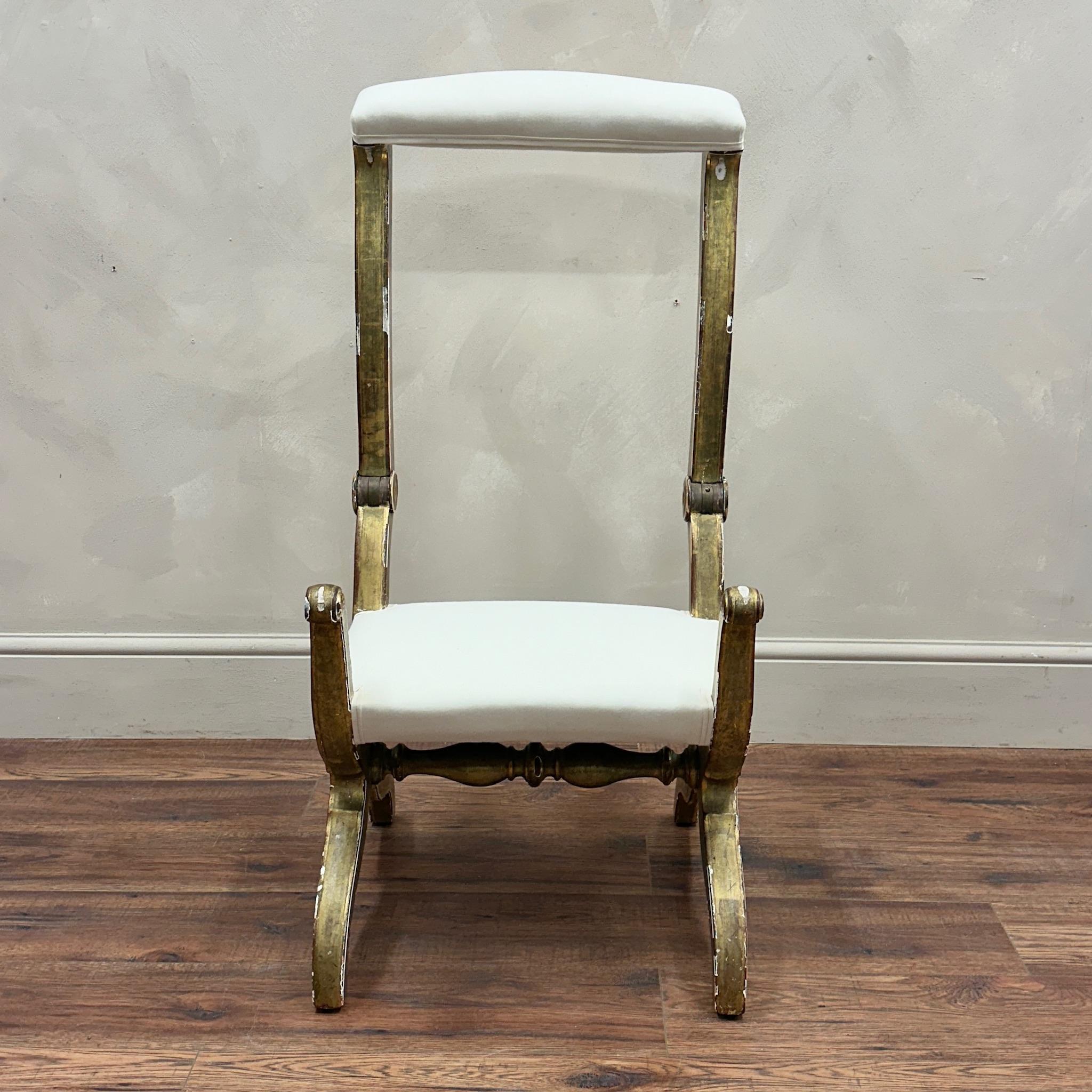 19th Century, French Metamorphic Prayer Chair.
Lovely original gilt paint frame, reupholstered in calico 
When the arms flip up it turns into a kneeling position hence why so called  a 