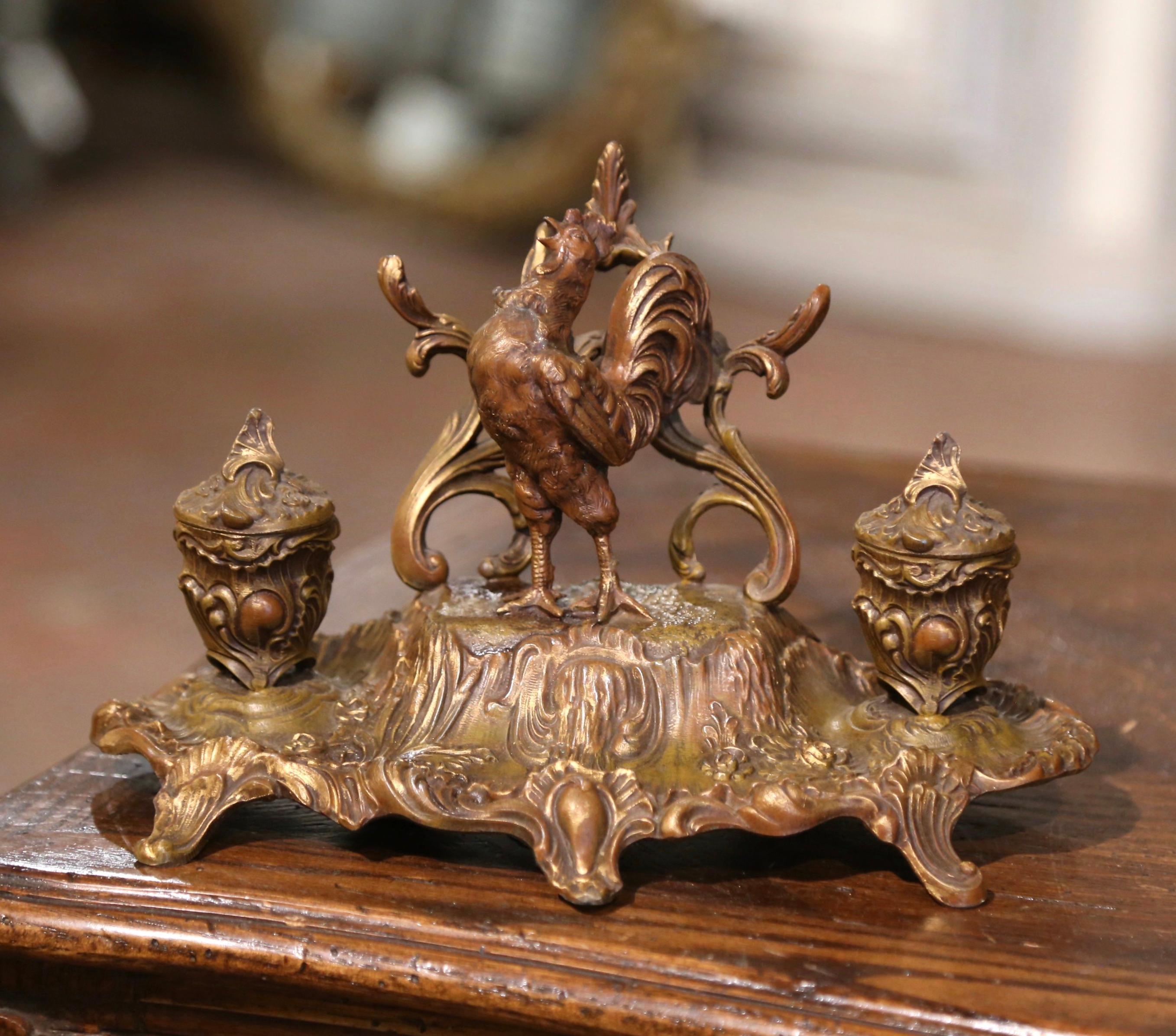 Place this elegant antique inkwell in a man’s office or study. Created in France, circa 1880, and built of spelter, the desk accessory sits on five small delicate curved feet, decorated with acanthus leaves, over a scalloped apron embellished with