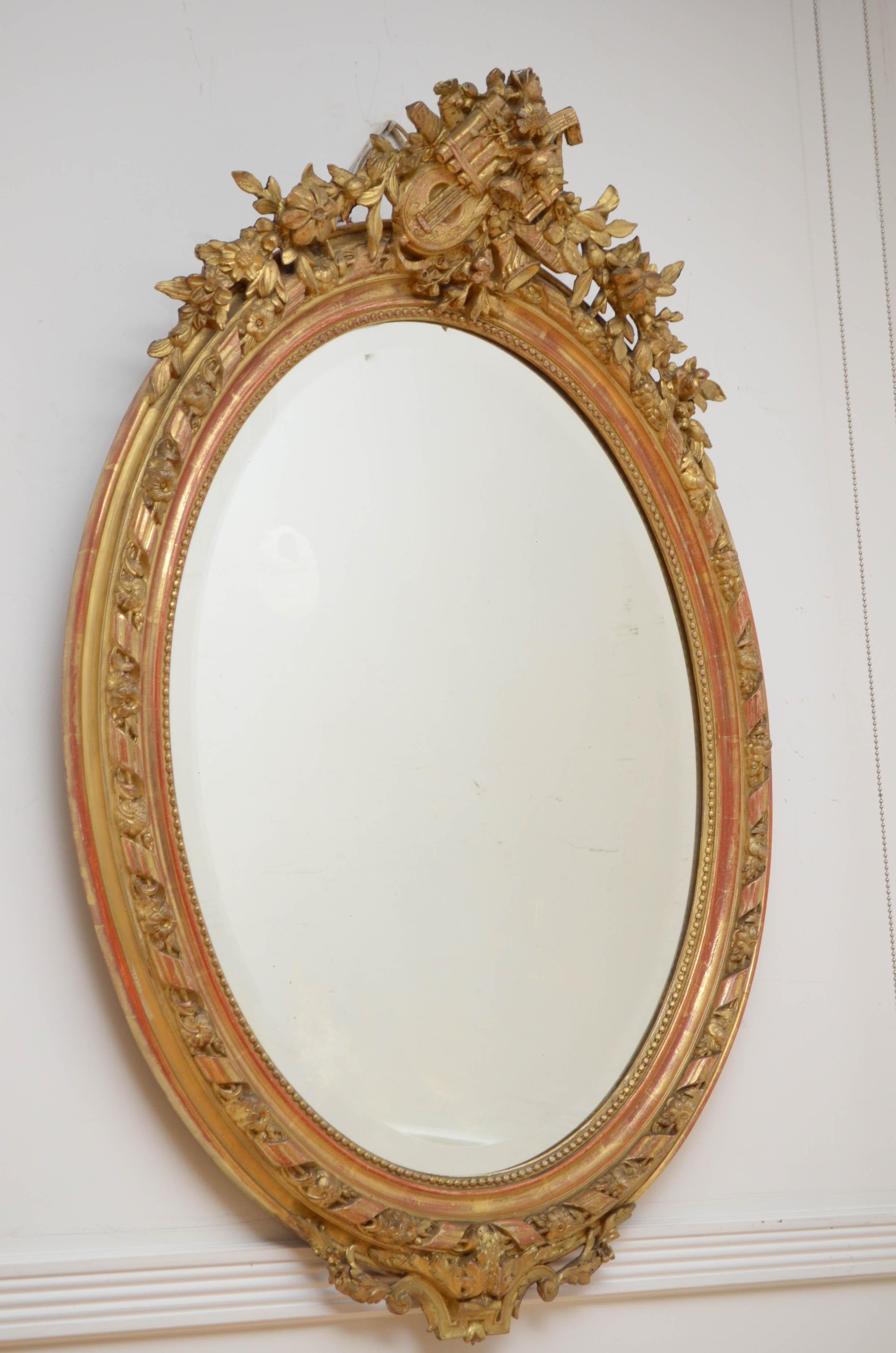 0218 Fine 19th century hand carved mirror in Belle Epoque Style, having original bevelled edge glass with some speckle in finely carved frame. The frame is carved with ‘les pearls’ which symbolises strand of pearls and leaf motifs throughout. The