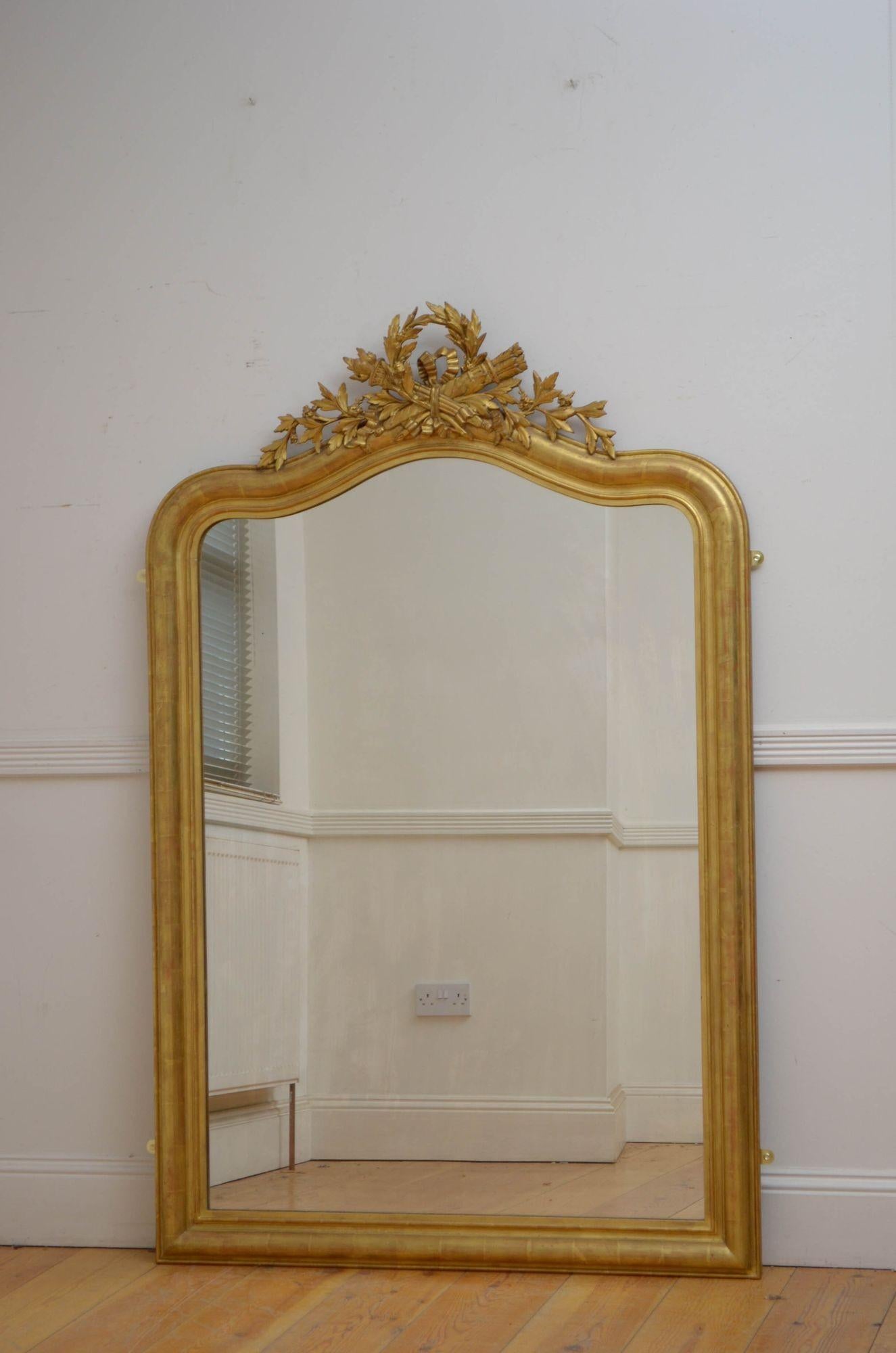 Sn5478 Fine antique gilded wall mirror, having original glass with minor imperfections in moulded frame with floral crest to the top centre. This antique giltwood mirror retains its original glass, original gilt and original backboards, all in home