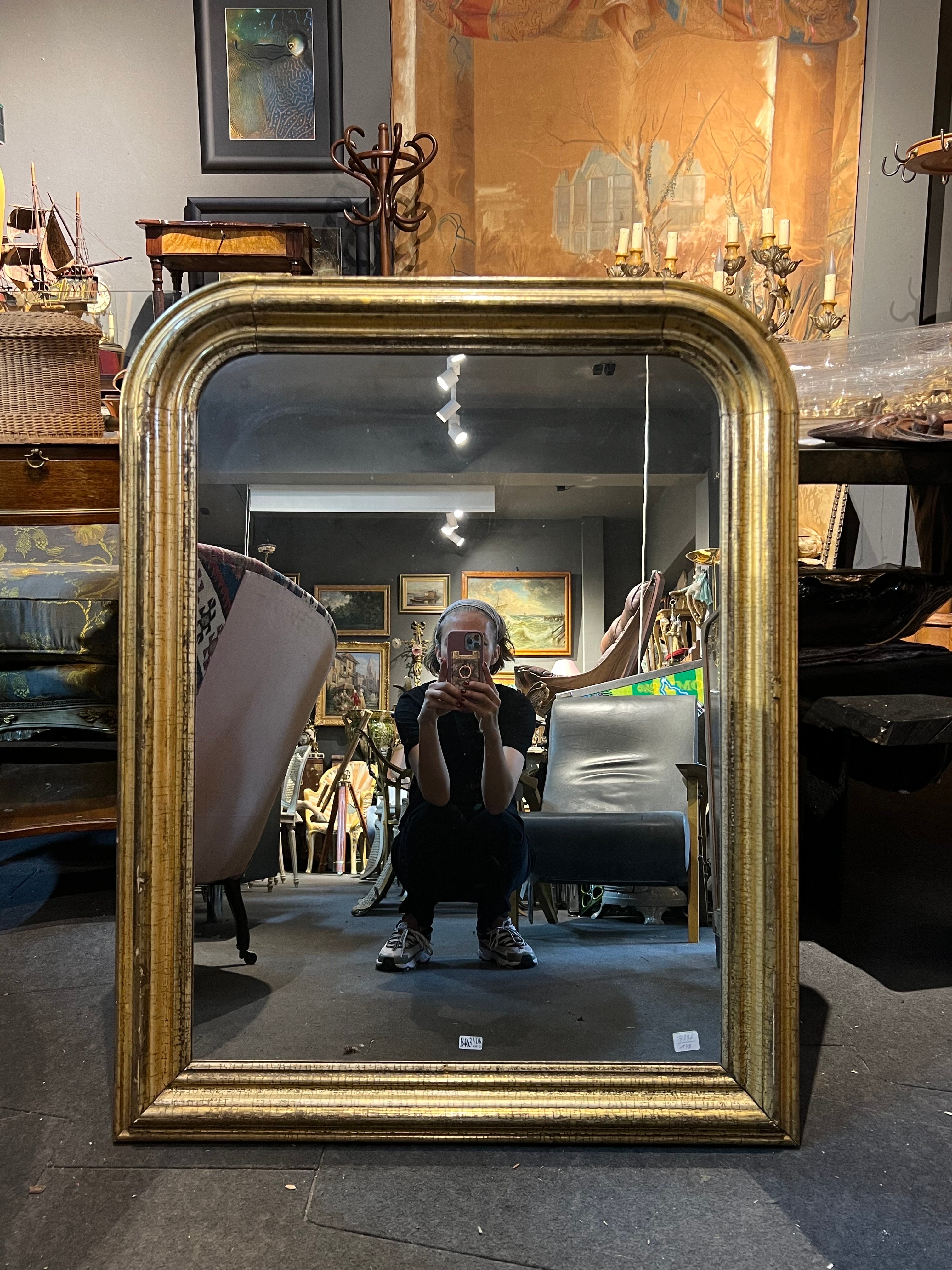 French large mantel mirror made in late 19th century. The frame is gilt wood in very good original condition with no restorations. 
