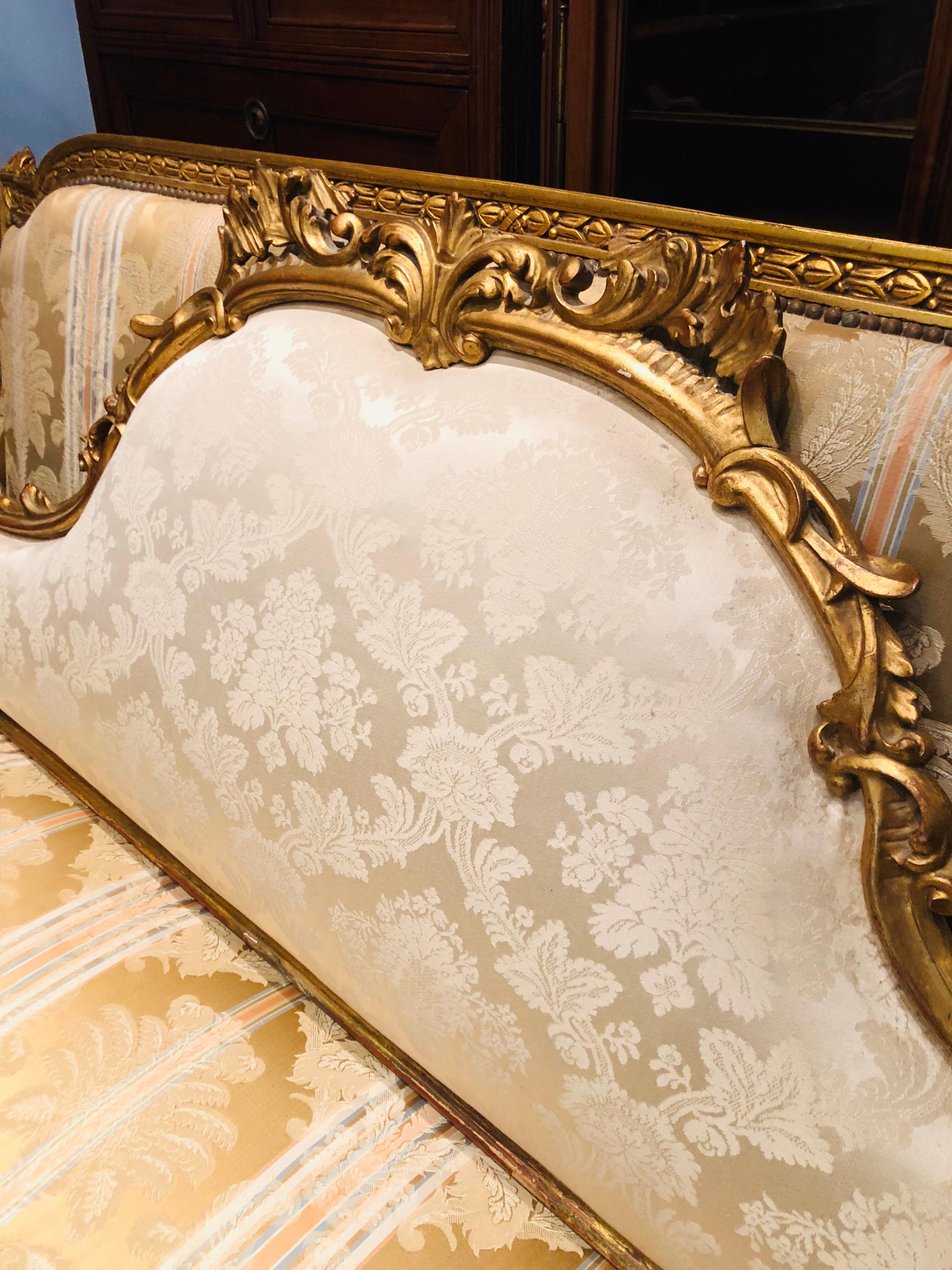 Rococo 19th Century French Giltwood and Hand Carved Bedhead in Light Beige Upholstery For Sale