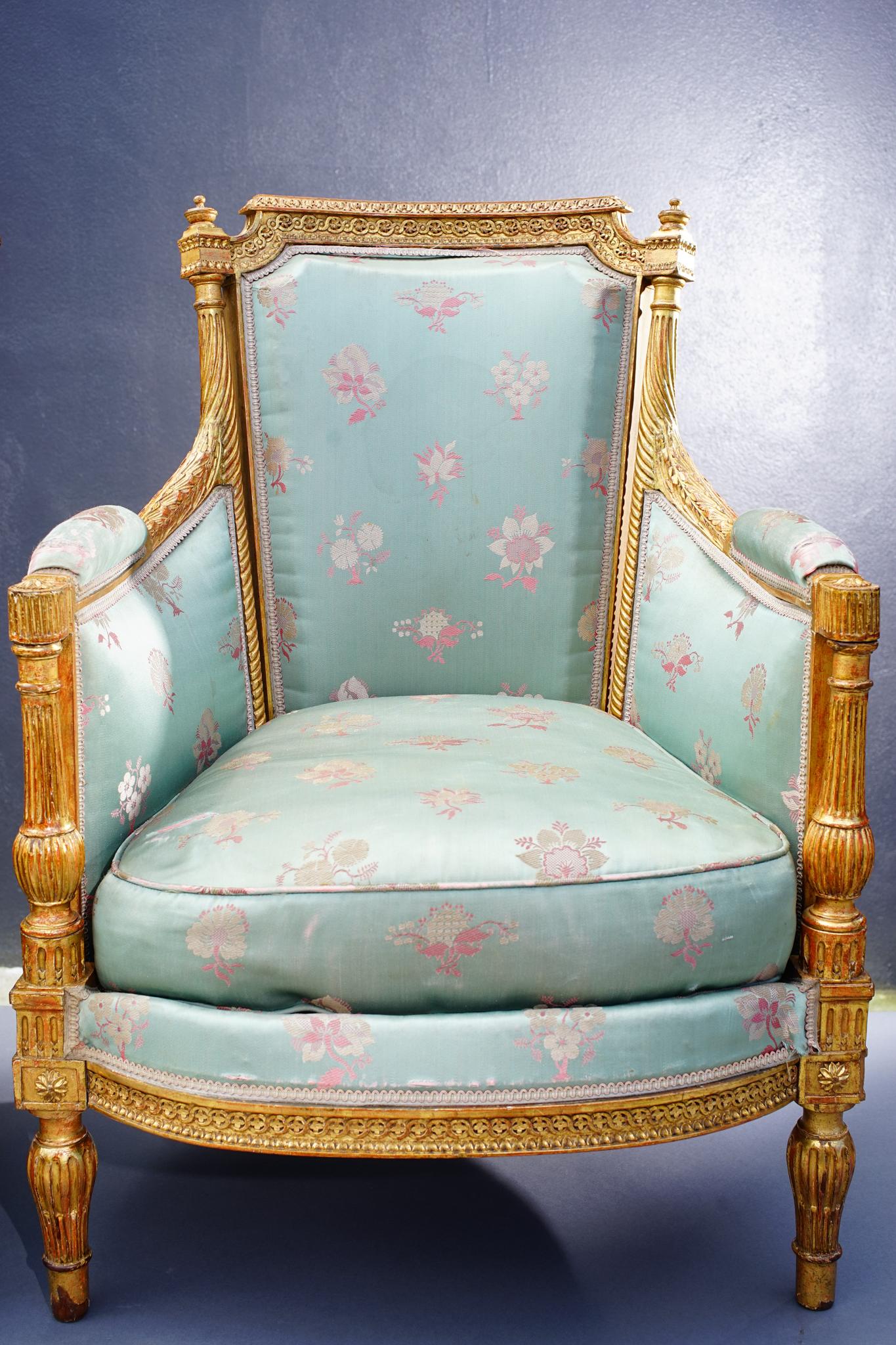 Very finely carved 19th century French giltwood armchairs upholstered in vintage silk.