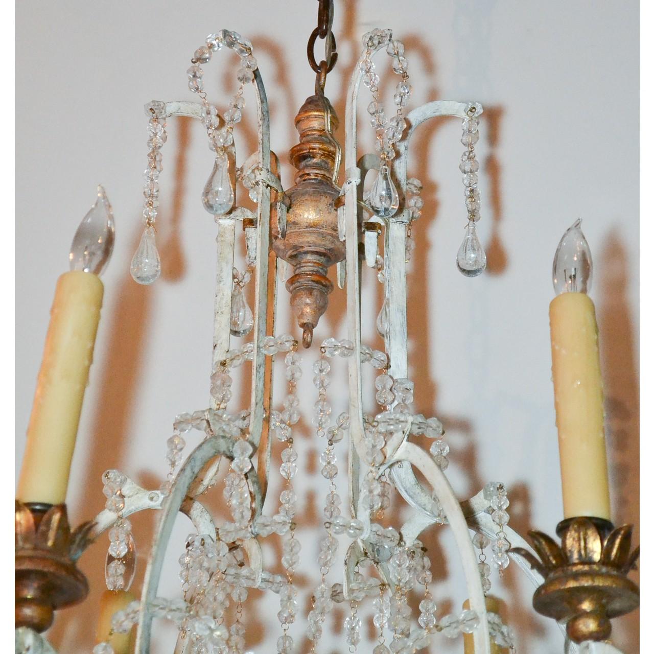 Lovely 19th century French giltwood and iron chandelier decorated overall with crystal beads and accented with crystal tear-drops. The contoured patinated iron arms with leaf-spray candle cups,

circa 1890.