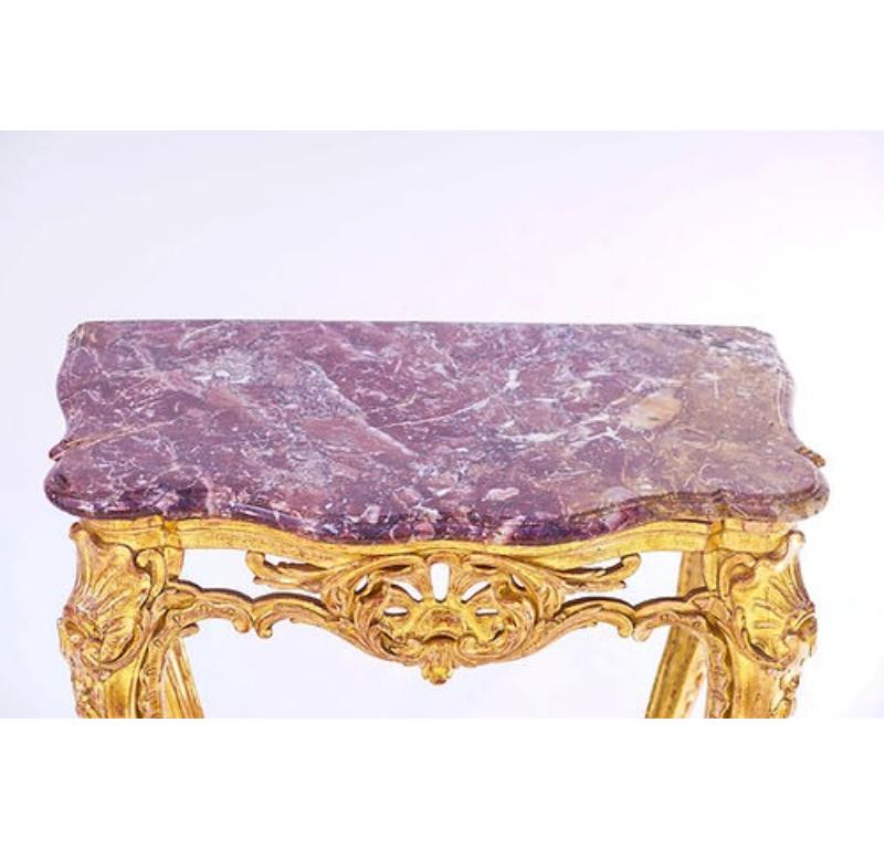 French Gilded Console with with Original Rouge Marble Top.

Gilting is not original but 22 karat... it's been re-gilted within the last 50 years.

Purchased from the famed Connoisseur Antique shop.