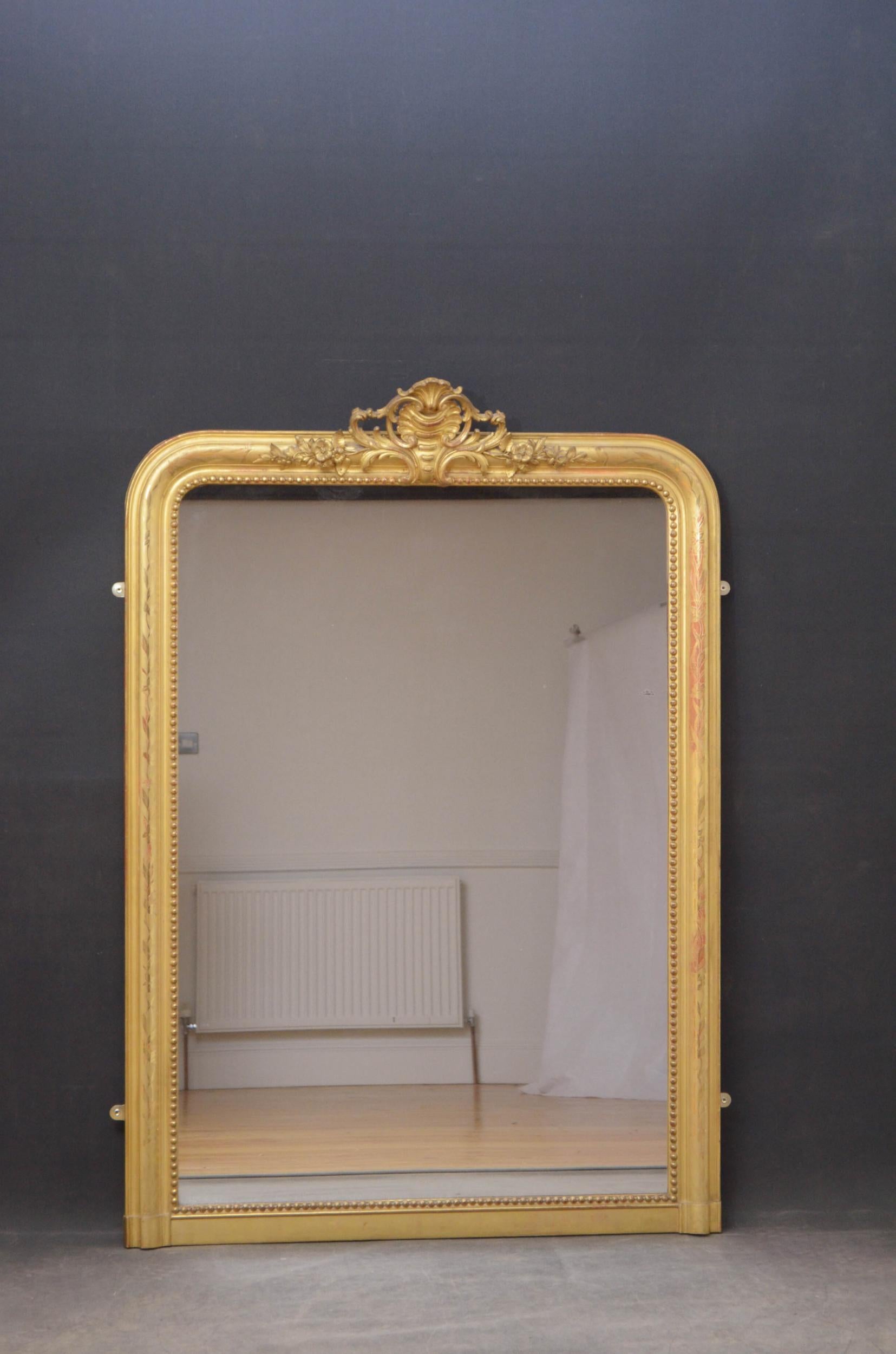 Sn4871 superb French gilded wall mirror, having original glass with some imperfections in beaded and gilded frame with and fabulous crest with scrolls and flowers to the centre and etched flowers decoration throughout. This antique mirror retains