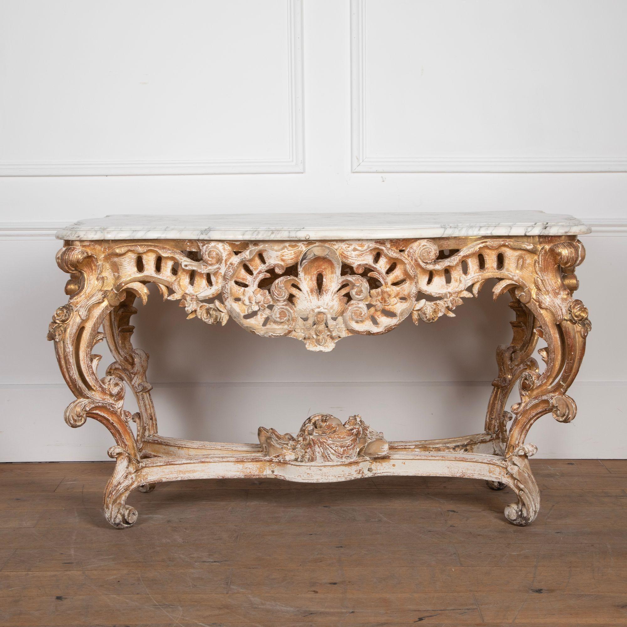 Stunning 19th Century gilded carved wood Rococo center table in the Louis XV style.
With a beautiful shaped Carrara marble top and carved decoration on all four sides with lovely wear to the gilding.
Small loses to the decoration in a few places