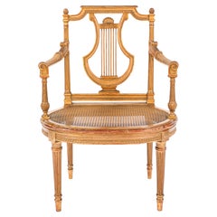 Silla con un solo brazo abierto de madera dorada francesa del siglo XIX