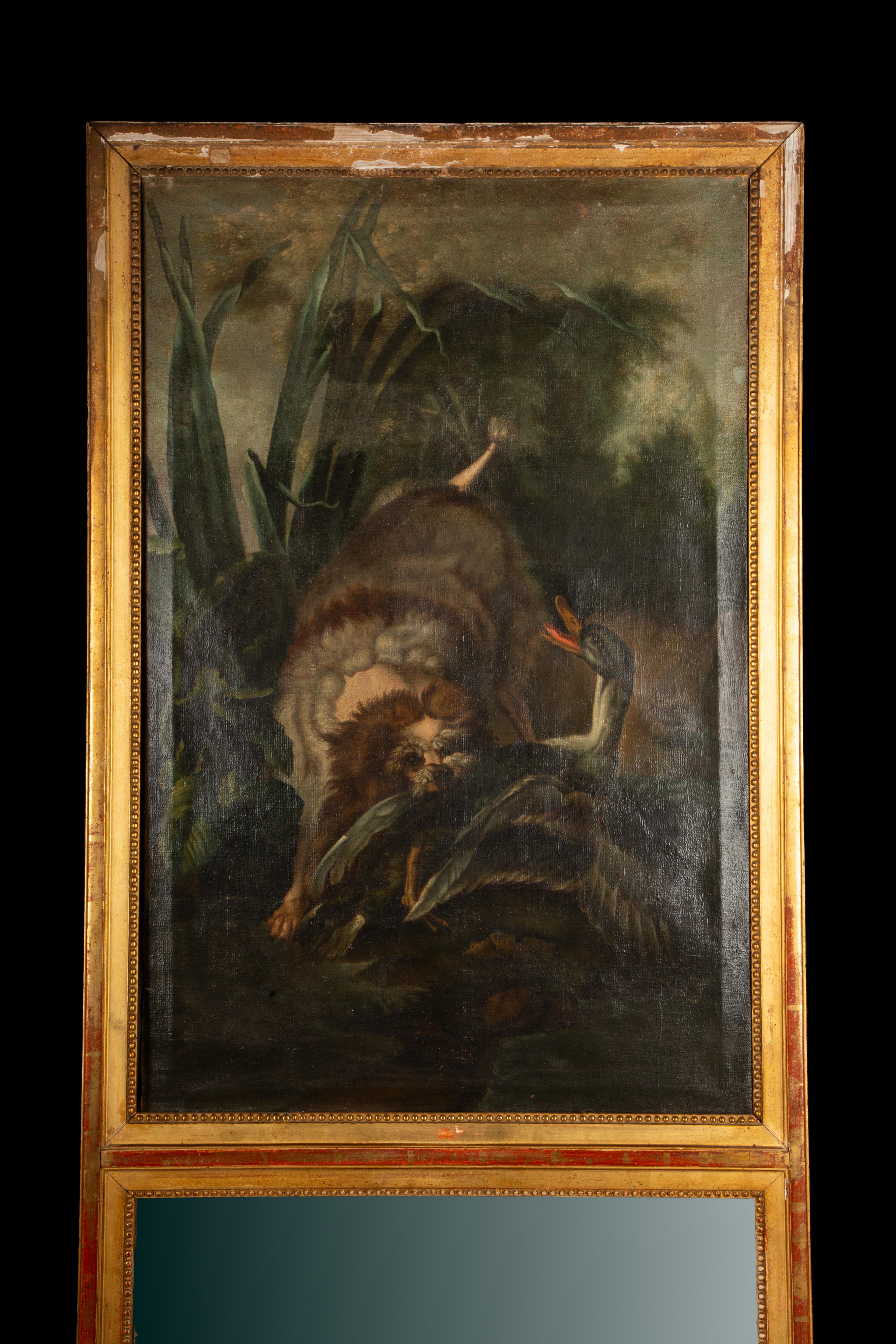 Un captivant miroir Trumeau français ancien du XIXe siècle, présentant une scène de chasse richement détaillée et peinte à la main. Le panneau supérieur présente une représentation spectaculaire d'un chien à la poursuite, capturant un oiseau au
