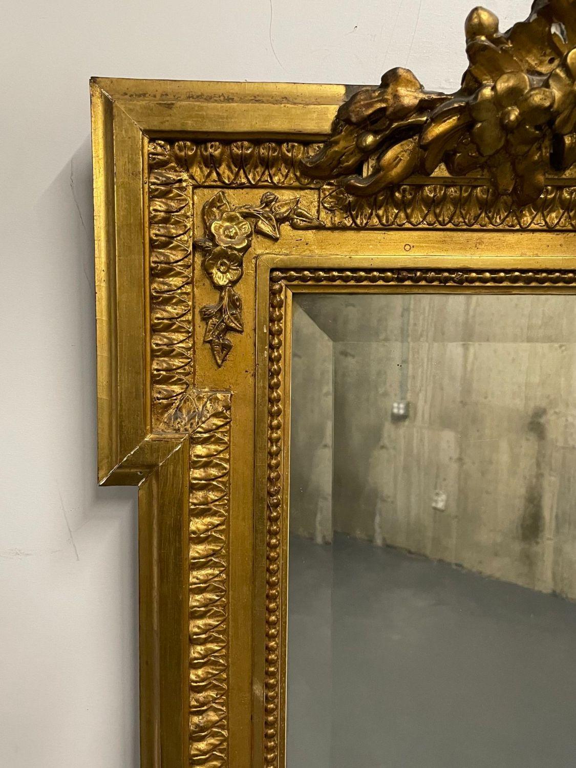 19th Century French Giltwood Wall, console, Pier mirror, Carved.

Finely carved and detailed beveled mirror. Mid to Late 19th Century with a bullet carved rectangular frame leading to an ornate pediment that is shell carved flanked by roses and