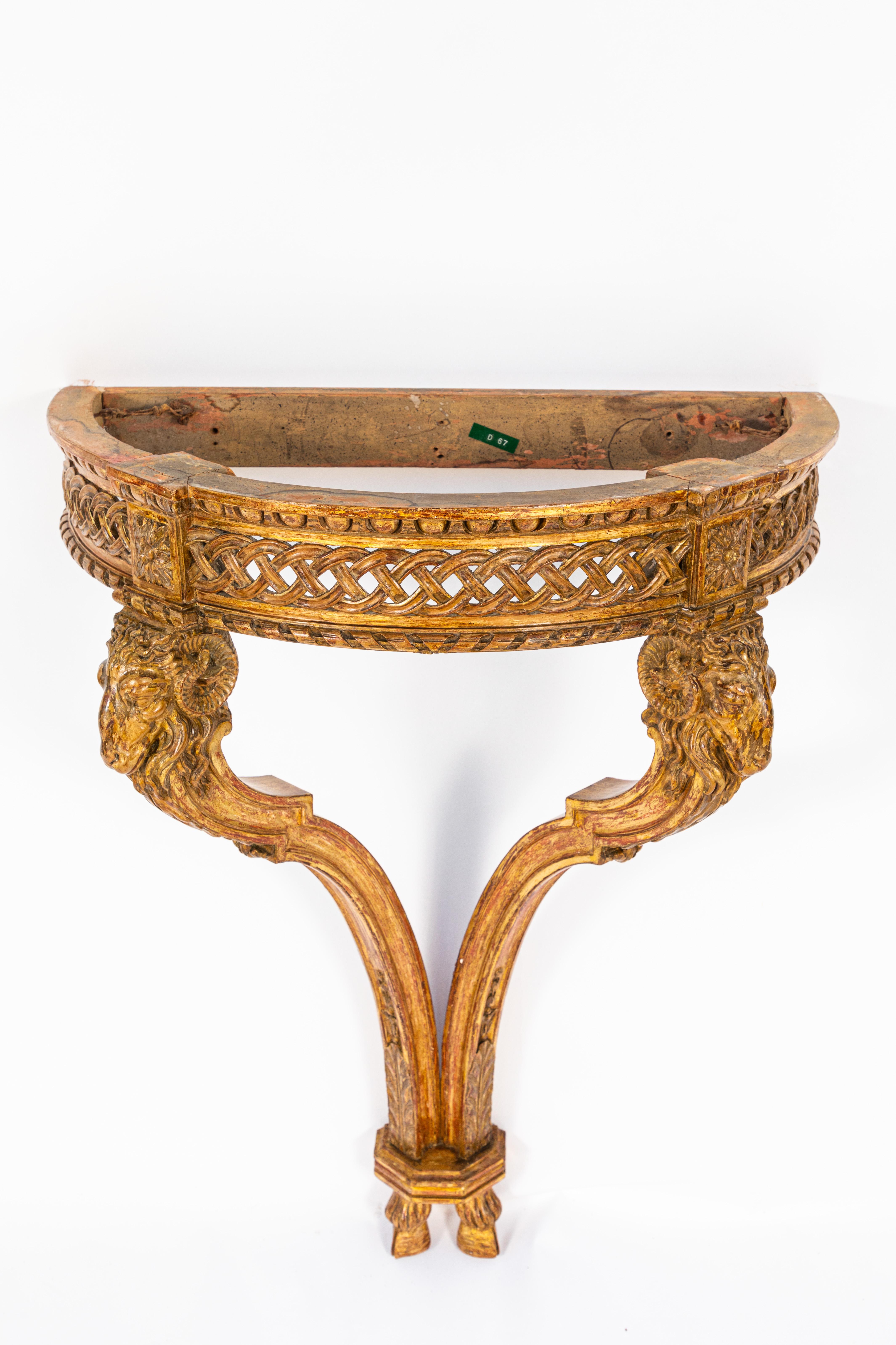 19th century French giltwood wall-mounted console with original marble. Very finely carved with ram's head motif.
