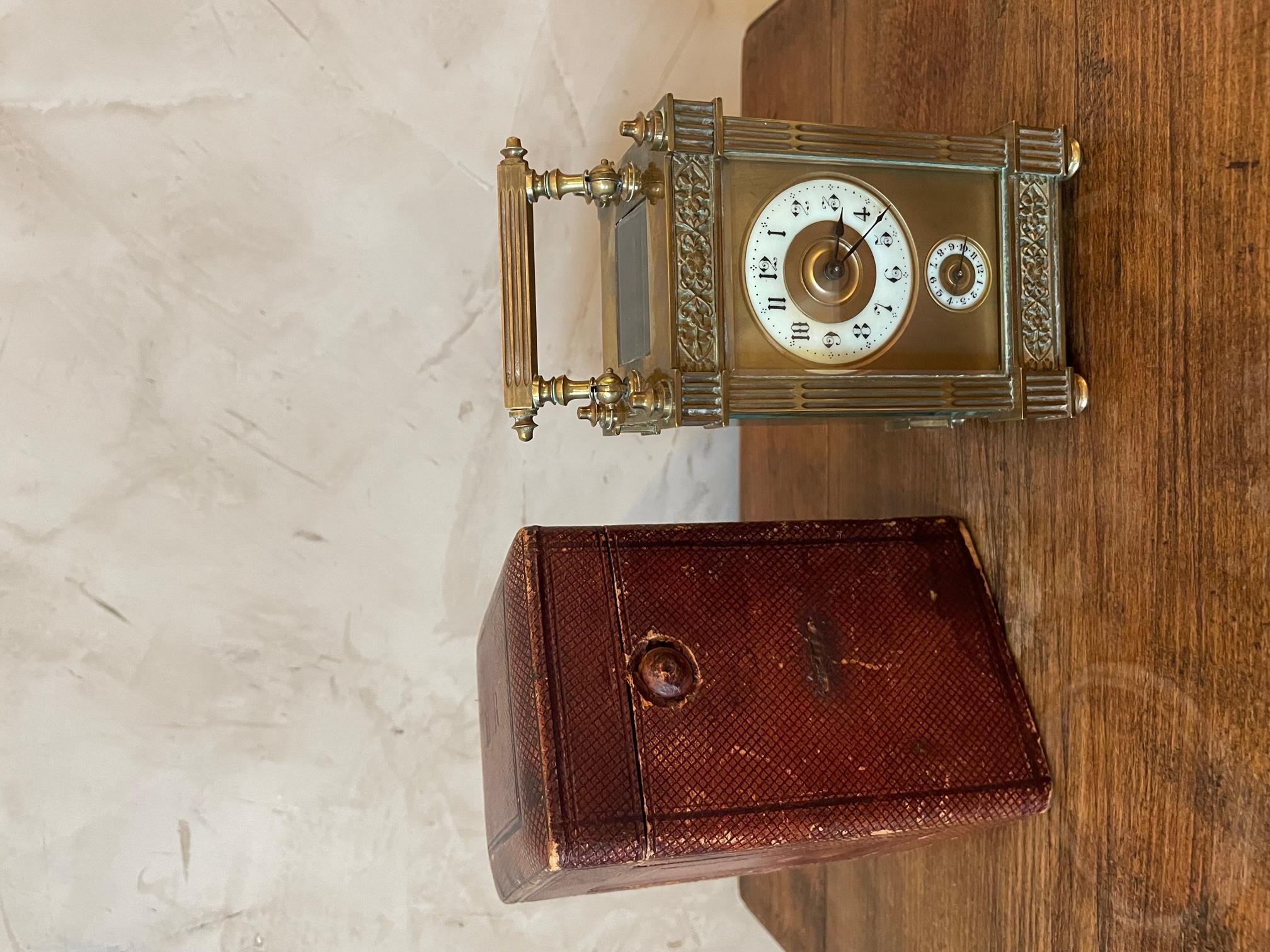 Working Beautiful 19th century French Officer's clock or travel clock made in Bronze and beveled glass panels showing the internal clock mechanism.
Folding handle. Opening glass door with the key on the inside. 
Opening boxe with H.R monogram.