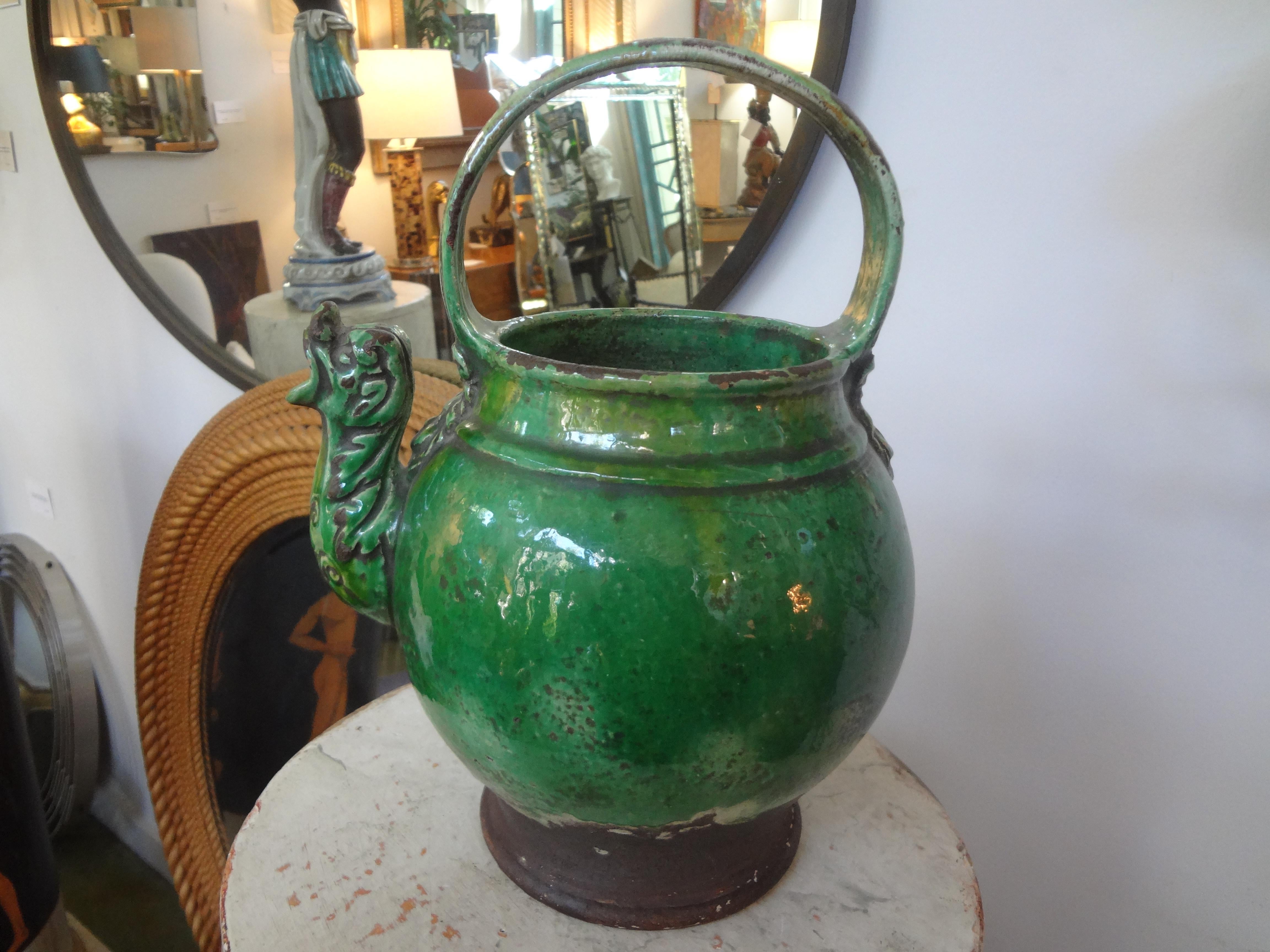 19th century French glazed terracotta vessel or pitcher.
A 19th century French green glazed terracotta pottery vessel or pitcher. This unusual vessel has a dragon spout and mask decoration. This vessel was used for milk or as a vinegar pot