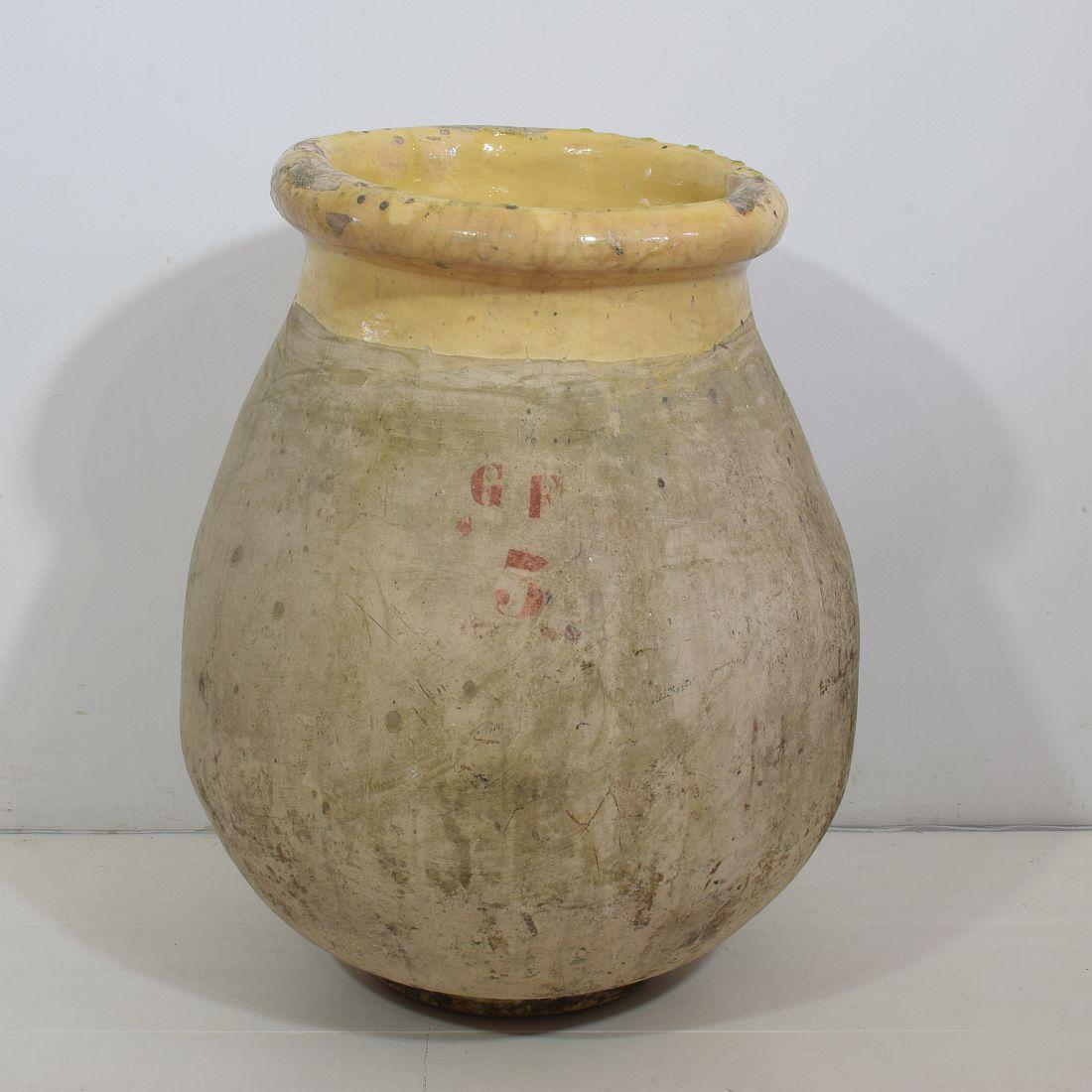 French Biot jar dating to the mid-late 19th century. Rounded shapely body with a rolled-edge yellow-glazed lip.
France, circa 1850-1900.
Weathered.