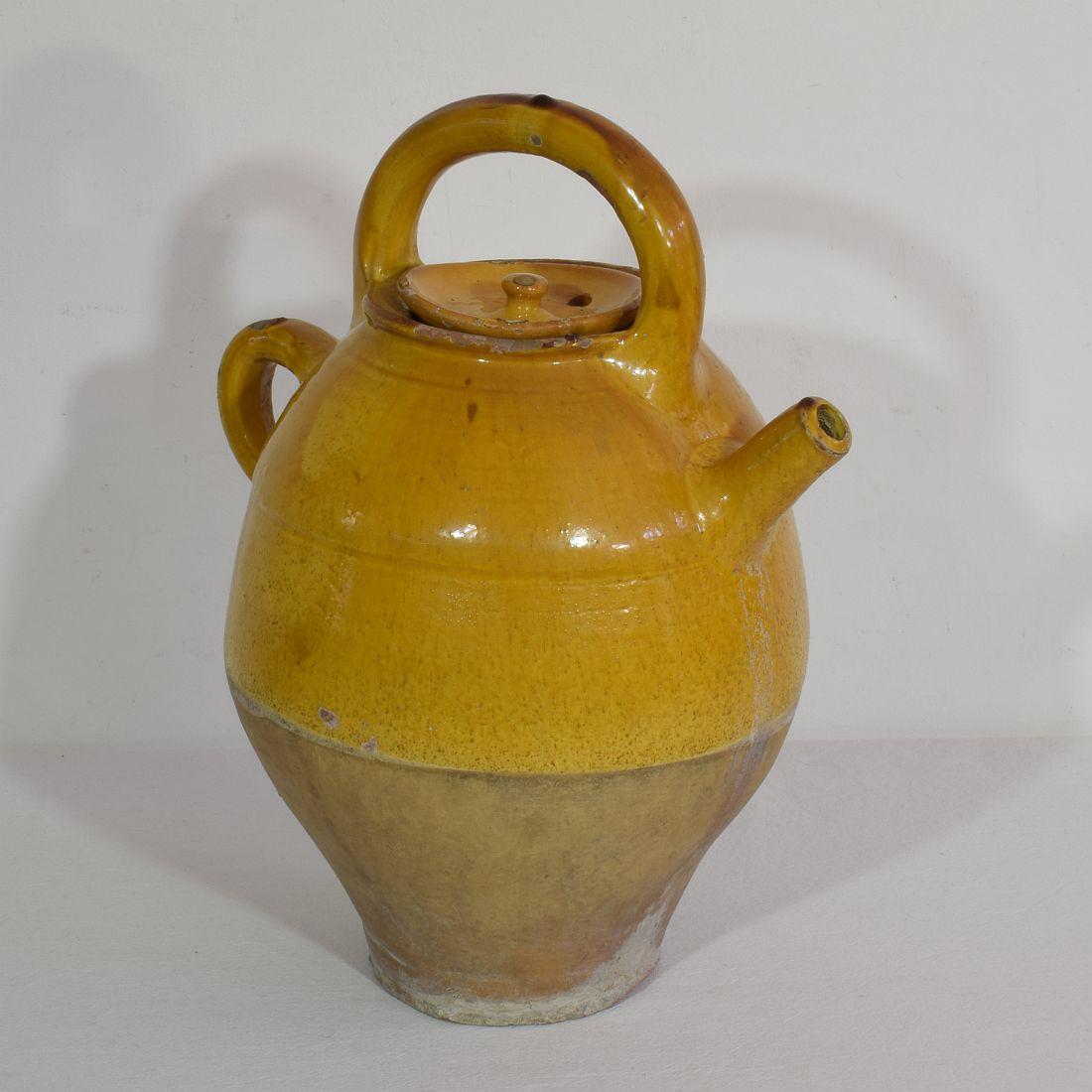 Great authentic and rare piece of pottery from the Provence. Beautiful weathered and an amazing color. Imperfections help authenticate this water cruche as it was an utilitarian type piece, France, circa 1850.