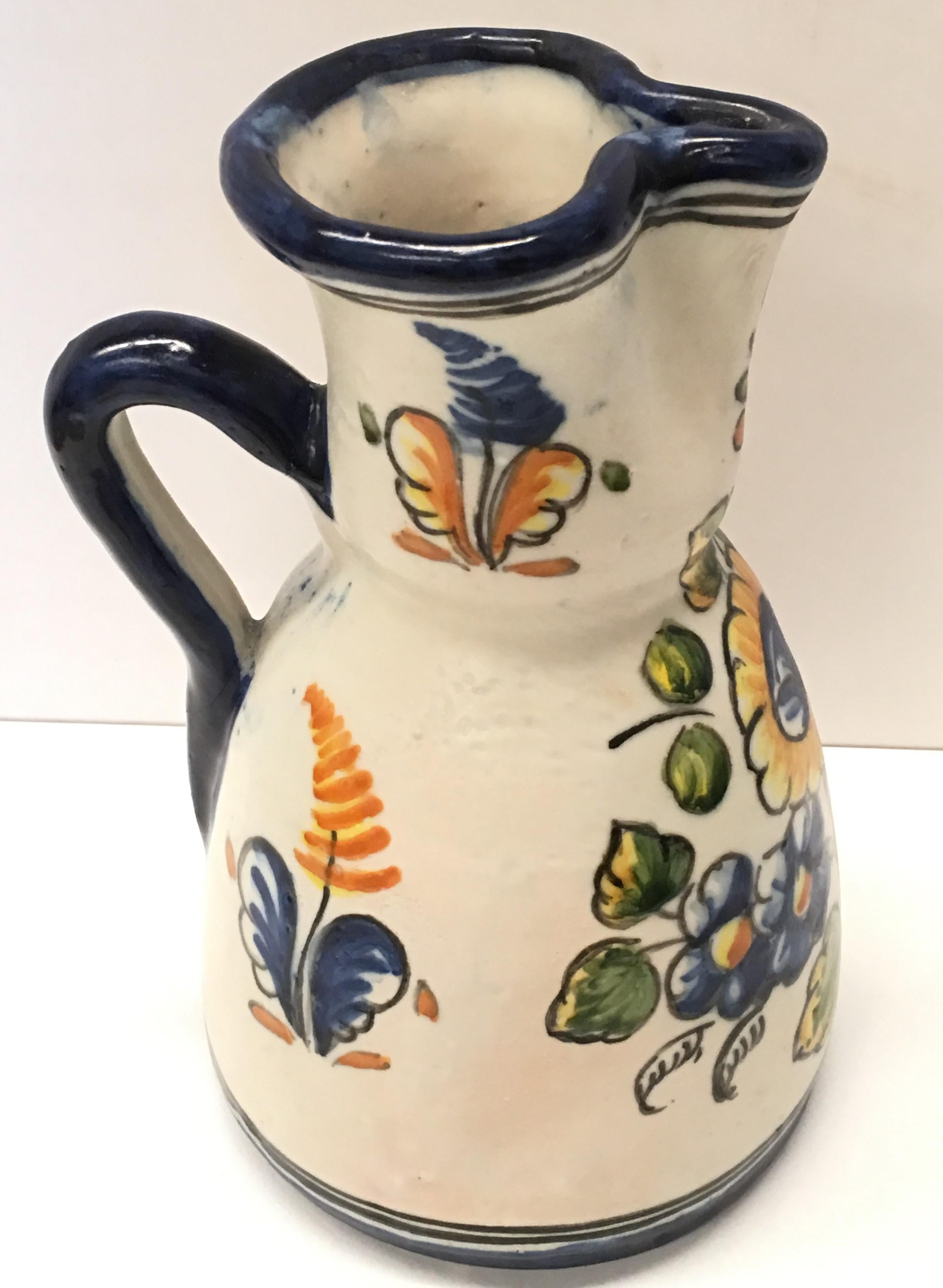 19th century French glazed terracotta pitcher with beautifuls fleurs.