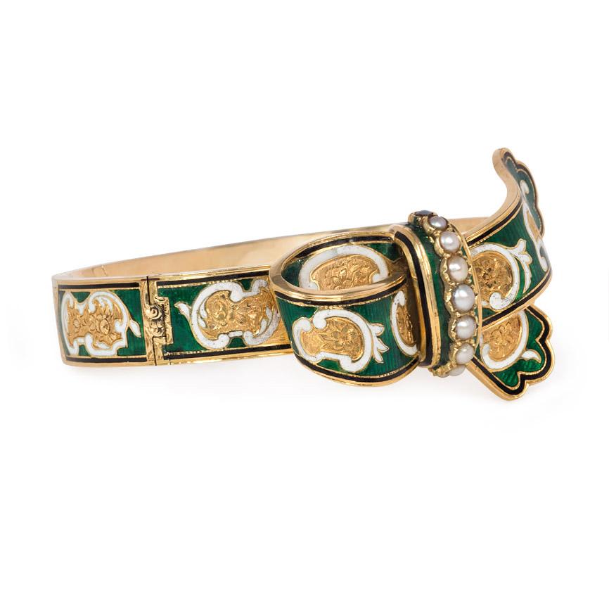 An antique gold bracelet designed as a buckled garter with green and white enamel paisley decoration and a row of half-pearls, in 18k.  France

Dimensions: 6