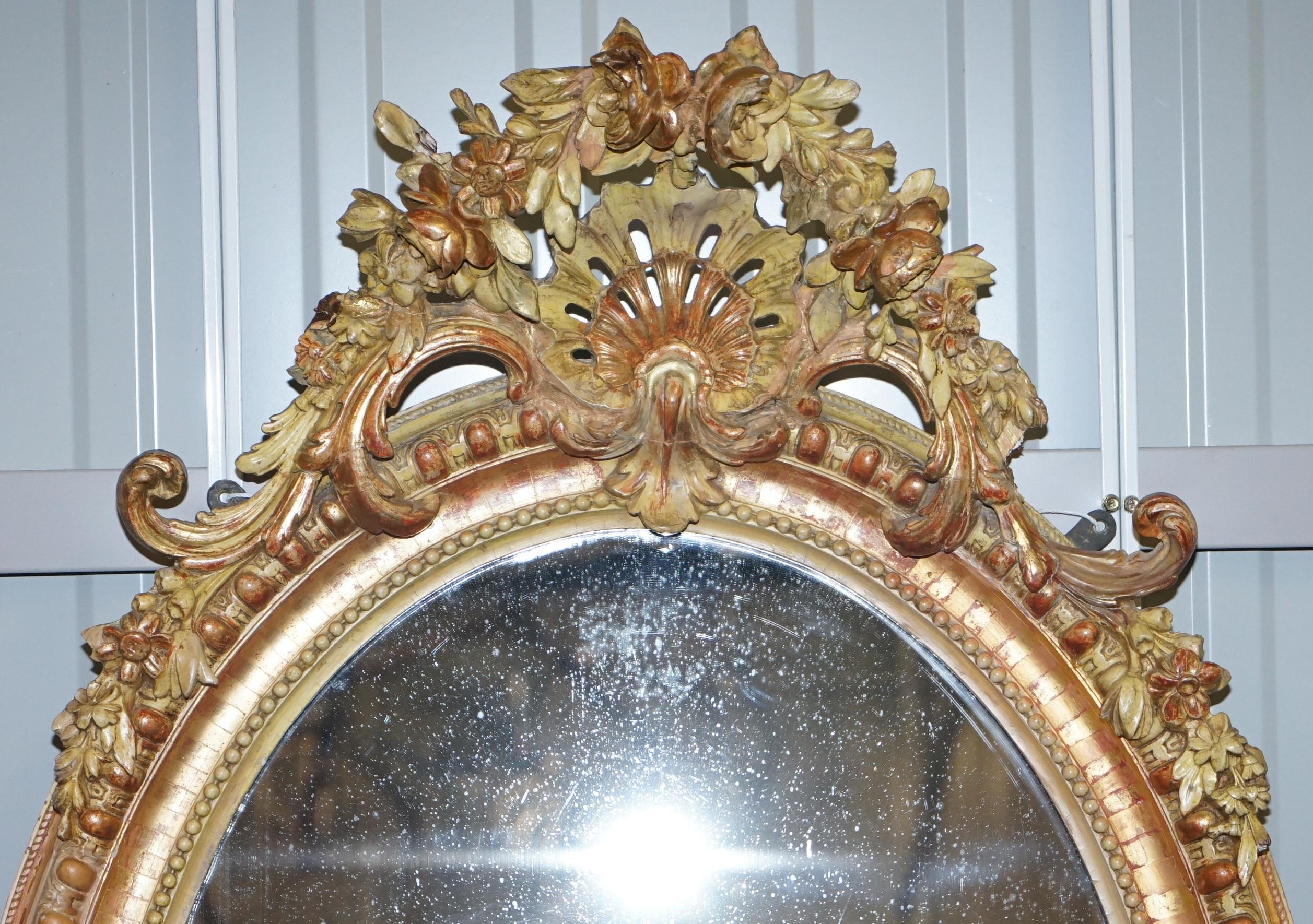 We are delighted to offer for sale this rare 19th century gold giltwood hand carved Gesso wall mirror

A very good looking well made and decorative 19th century French oval mirror, the floral and shell Gesso work is all carved from one solid piece