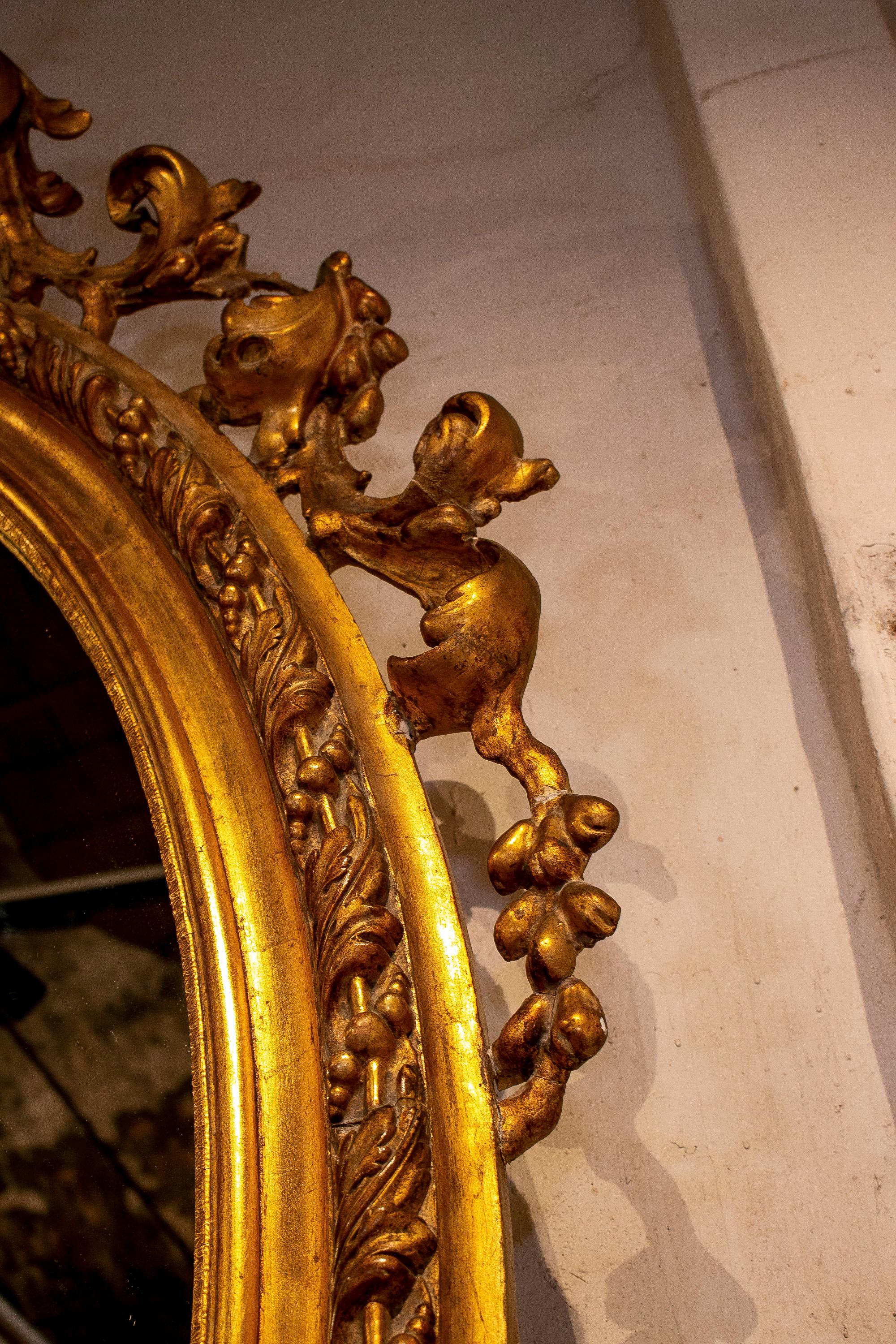 Espejo ovalado francés del siglo XIX de madera dorada con cresta y rocalla barroca en venta 6