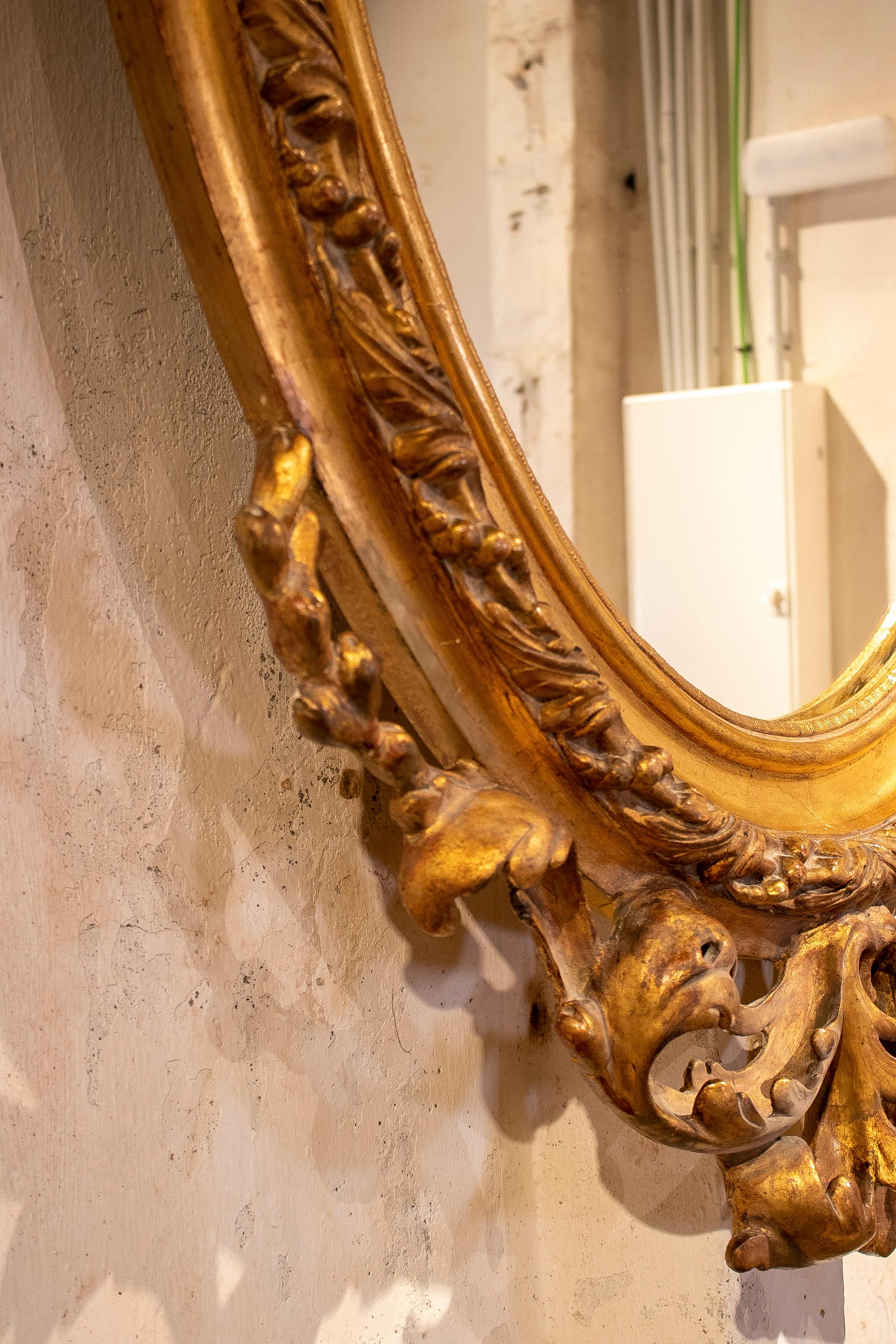 Espejo ovalado francés del siglo XIX de madera dorada con cresta y rocalla barroca en venta 9