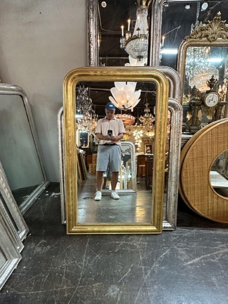 Very fine 19th century French gold leaf Louis Philippe mirror. This piece has an interesting graphic design as well as a beaded inner border. So pretty!!