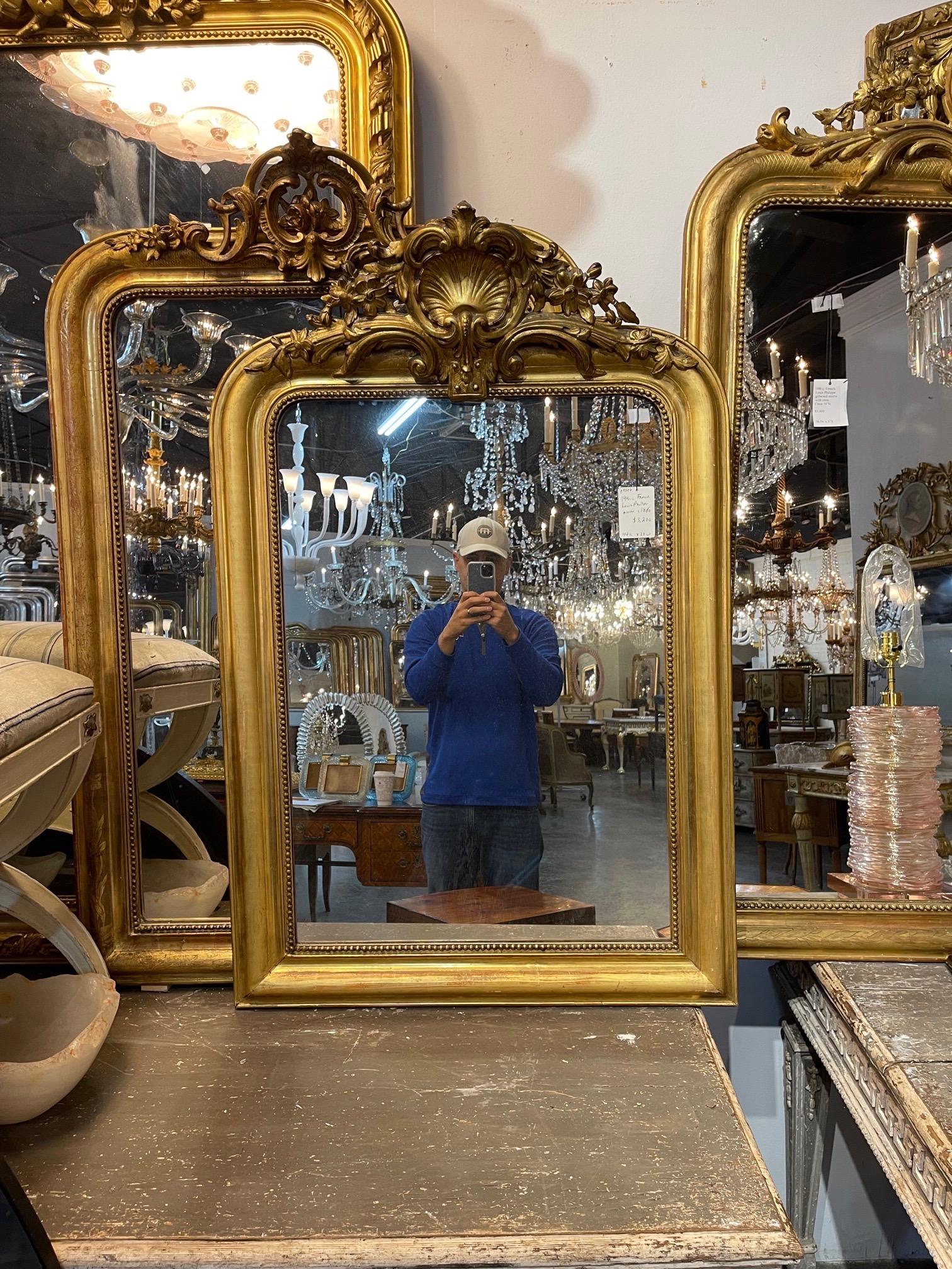 Beautiful 19th century French gold Louis Philippe mirror with an elaborate crest at the top. Very fine carvings and nice patina as well. Superb!