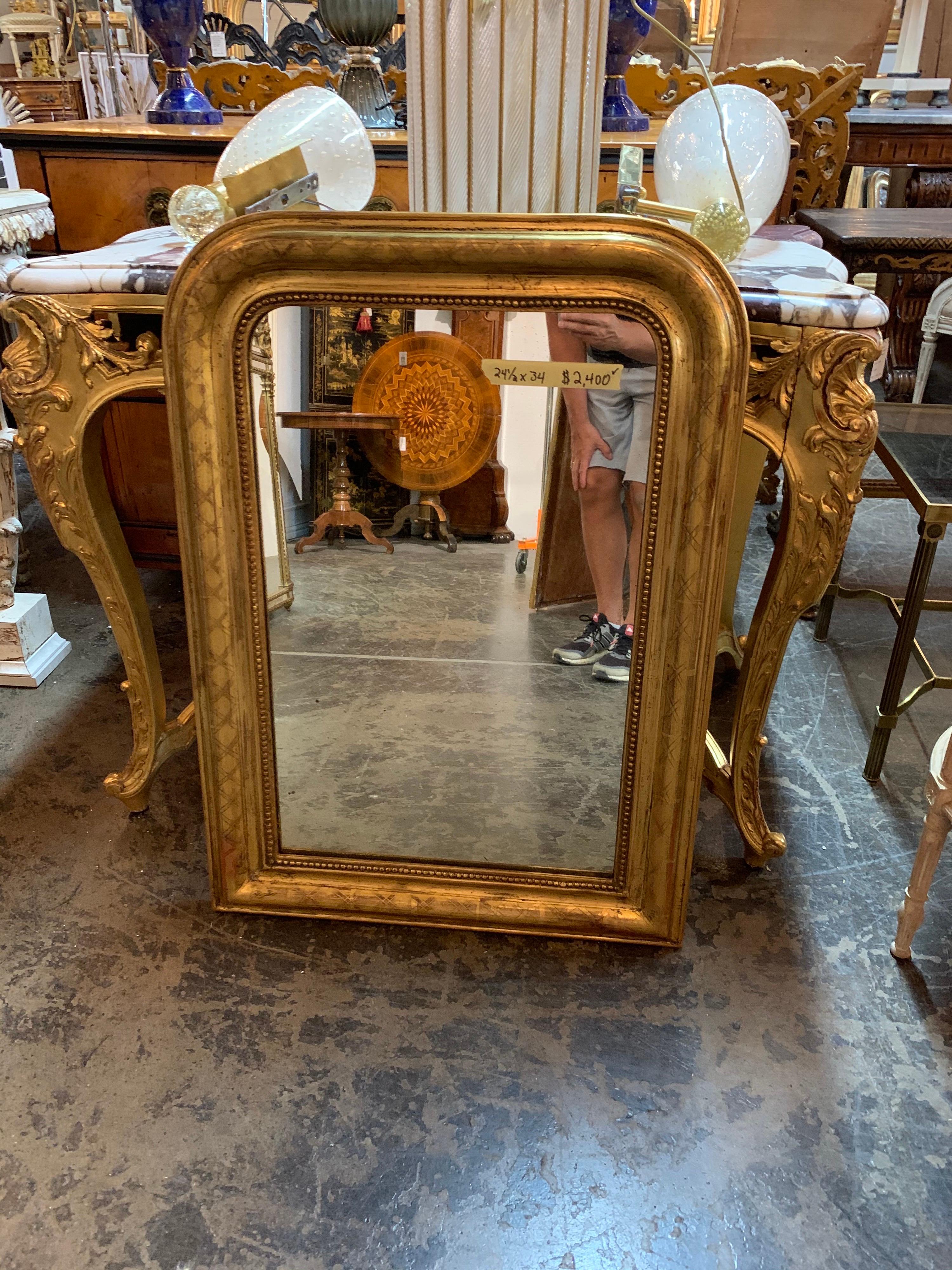 Fabulous 19th century French gold Louis Philippe mirror with X-pattern. The mirror also has a beaded inner border. Great for a variety of decors!!