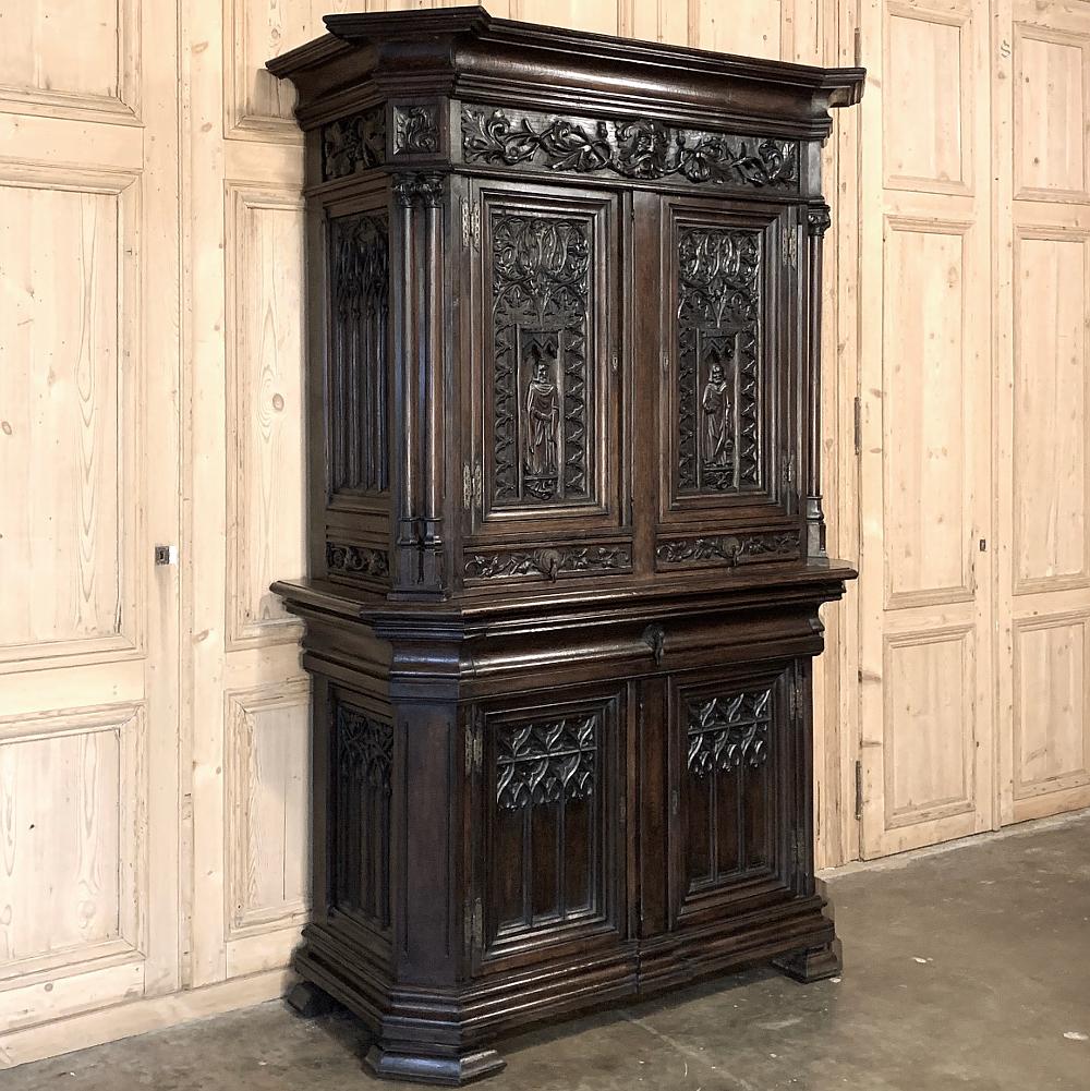 19th century french Gothic buffet a deux corps, cabinet represents the epitome of classical architecture festooned with Gothic style carvings between the boldly molded crown and equally bold base. Mitered corners are adorned with carvings under the