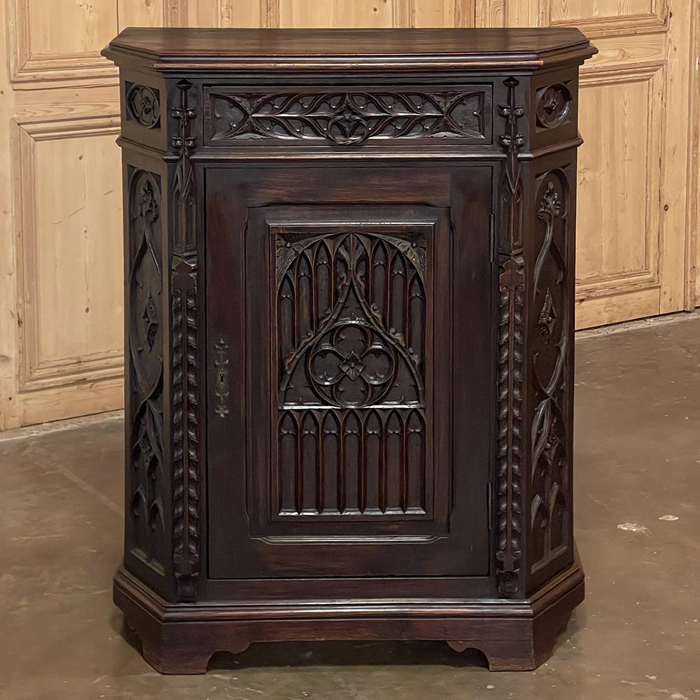 19th century French Gothic Confiturier ~ cabinet is a stunning example of the revival of the oldest official French style, with origins dating back to the middle of the 12th century! The intriguing half-octagon shape of the casework presents an