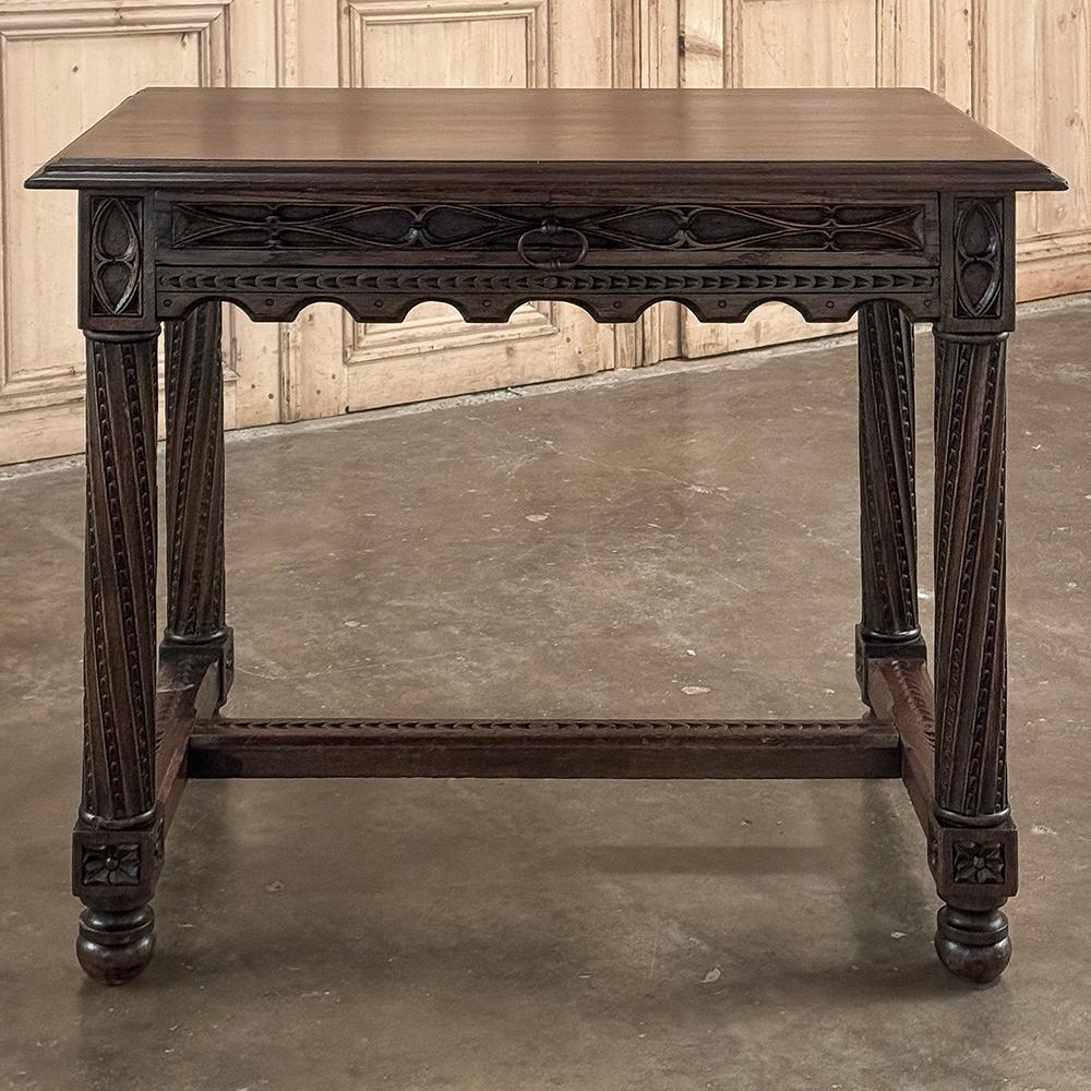 19th Century French Gothic End Table is a relatively tailored and sedate rendition of the style, which dates back to the 12th century in France!  Double beveled plank top rests on an apron carved on all sides with geometric molded detail, including