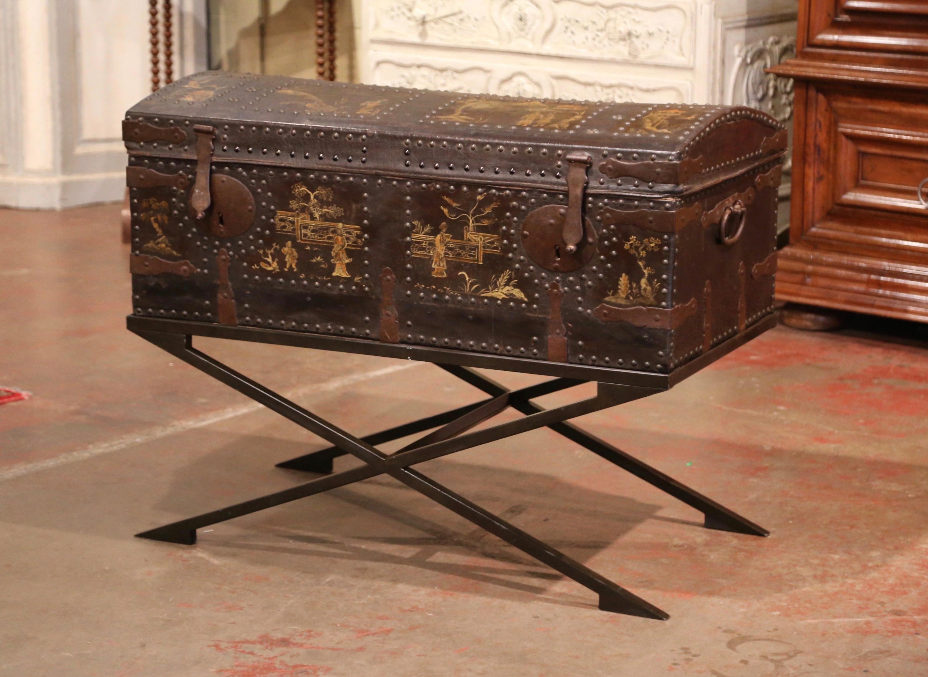 Decorate a hallway or game room with this elegant antique trunk; crafted in France circa 1830, the Gothic blanket coffer stands on a double X-shape stand. With a dome shape, the leather chest is decorated with hand painted gilt chinoiserie landscape