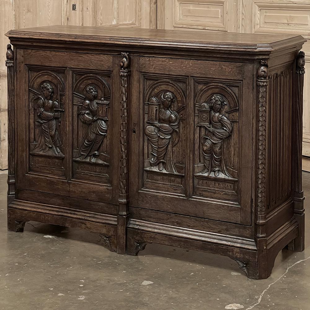 19th century French Gothic oak buffet is a marvel of hand-worked craftsmanship and the sculptor's art, all in one piece! Rendered from old-growth oak, it features linenfold panels on each side, with mitered corners leading the eye to the central