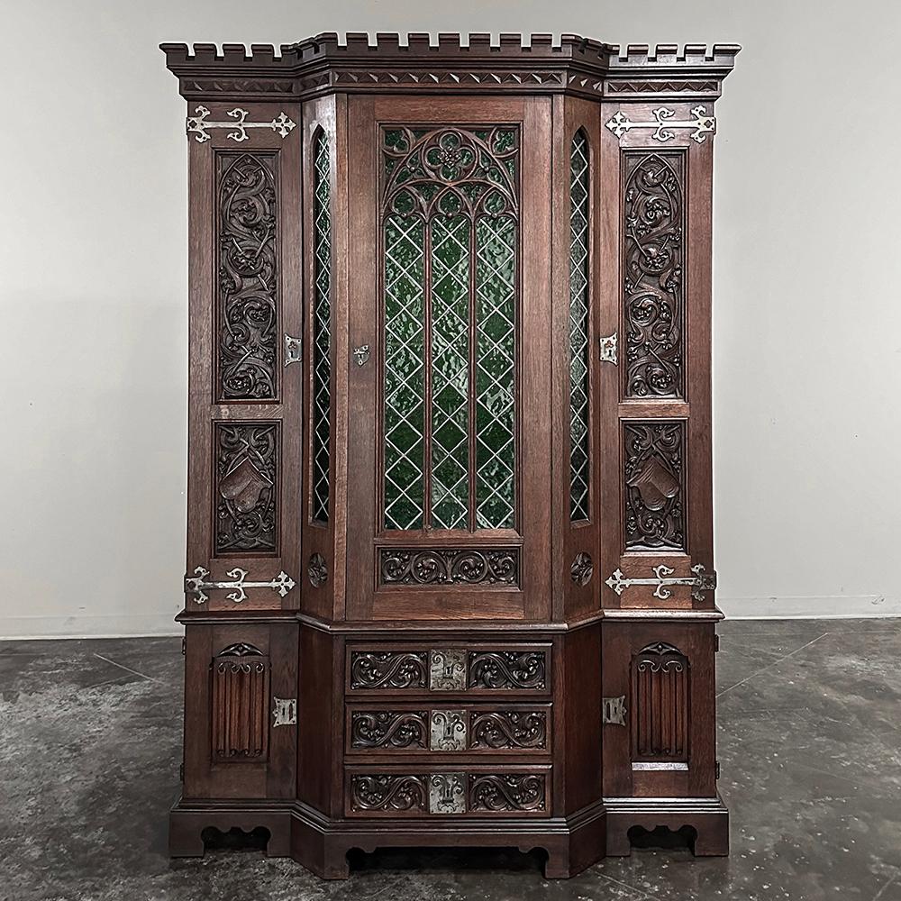 19th Century French Gothic Revival Bookcase with Stained Glass is a stunning example of the genre, produced from solid oak on a scale large enough to impress, but not too large to fit in most any room.  The design is also space friendly, as the