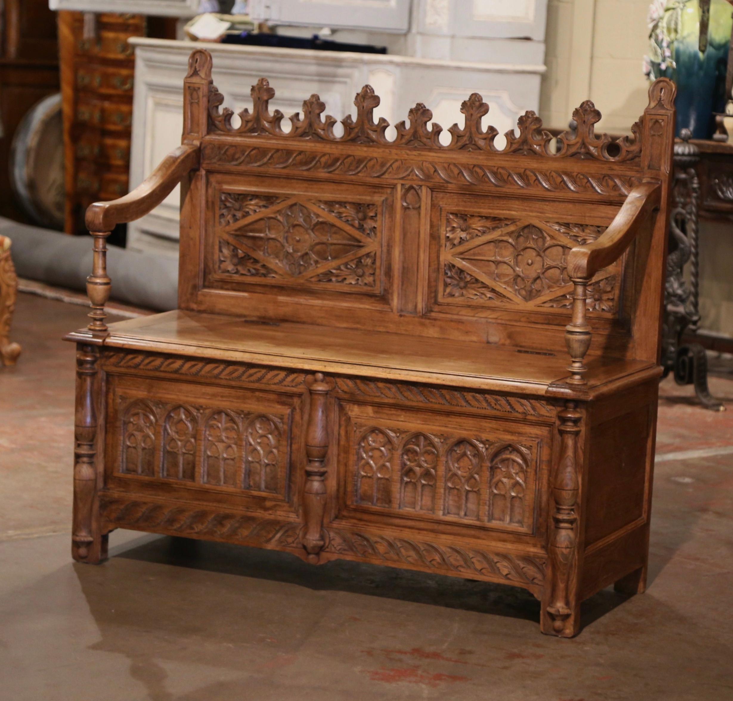 Compliment your entryway, hallway or mud room with this heavily carved antique bench. Crafted in northern France, circa 1880, and built of solid oak wood, the bleached Renaissance style bench stands on square feet over a straight carved apron. The