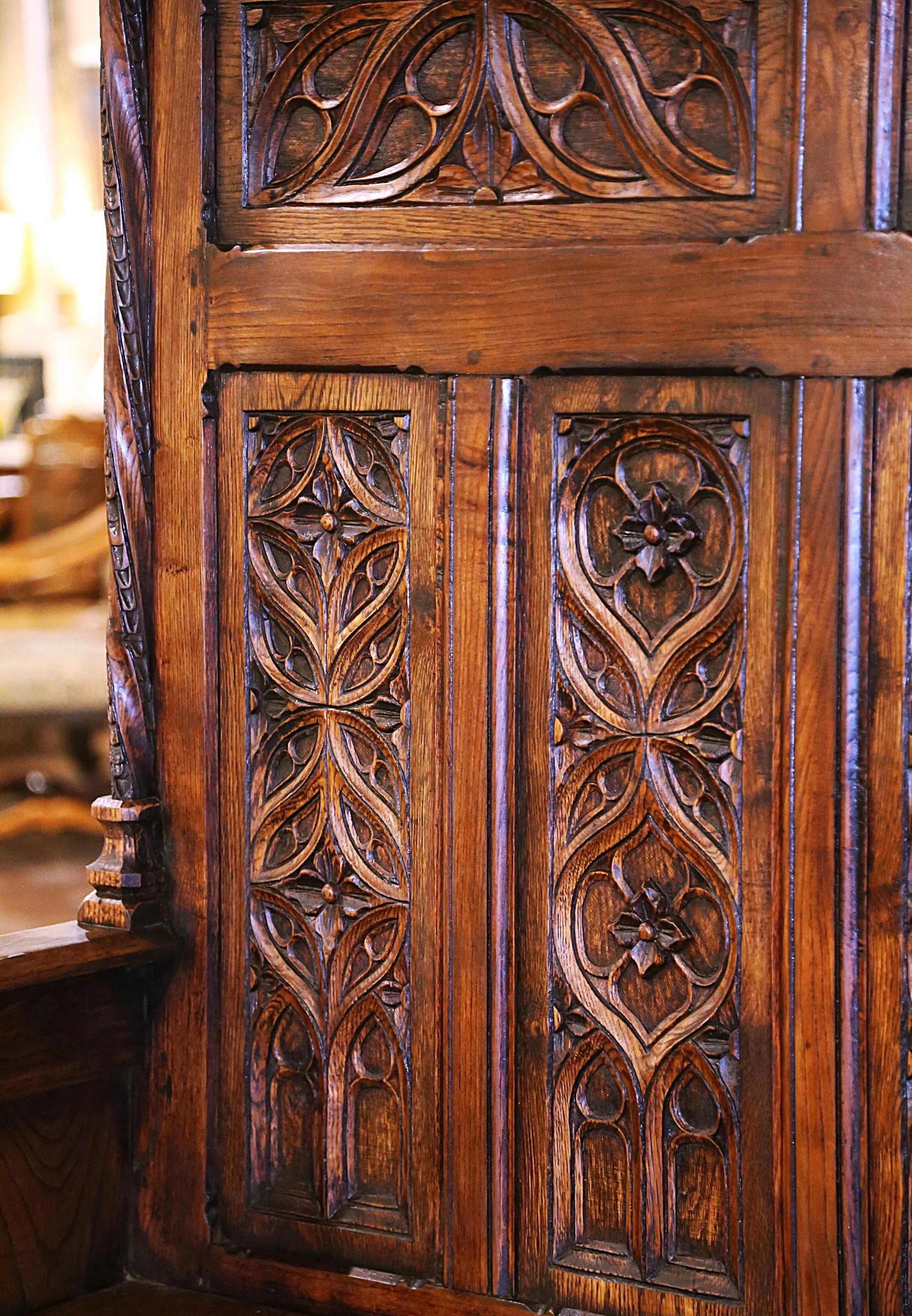 Compliment your entryway, hallway or mud room with this heavily carved antique bench. Crafted in northern France, circa 1870, and built of solid oak wood, the Renaissance style bench stands on a straight carved apron. The tall back features two