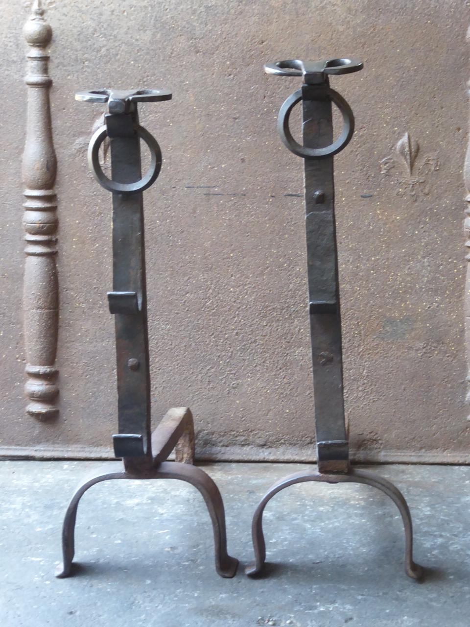 19th century French Gothic style andirons. The tops of the andirons consist of bull heads which is characteristic for this type of andirons. In France these andirons are called 'landiers'. They are made of wrought iron. The condition is