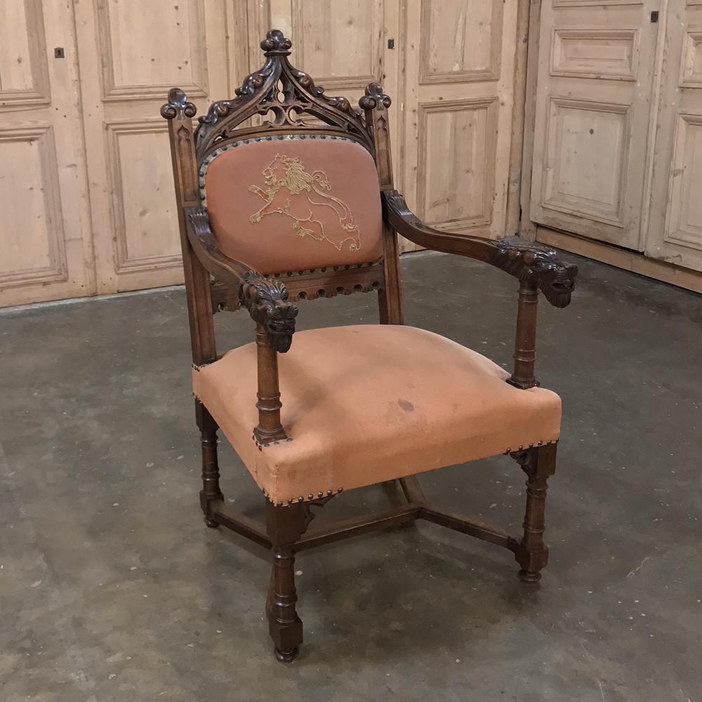 ce fauteuil gothique français du XIXe siècle en noyer avec broderie présente un design intemporel avec un attrait visuel comprenant des flèches, des formes naturalistes et des têtes de lions sur les accoudoirs. Le style remonte au milieu du 12e