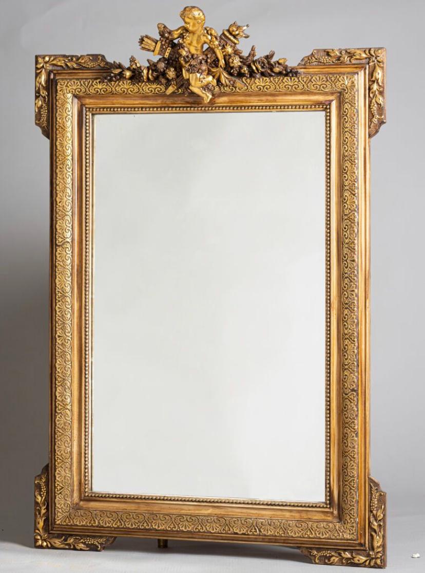 19th Century French crystal mirror in grand stucco and gilded wood frame decorated with a putti holding a quiver and a torch on the top. Very good authentic condition with no restorations made so far.
Napoleon III period.