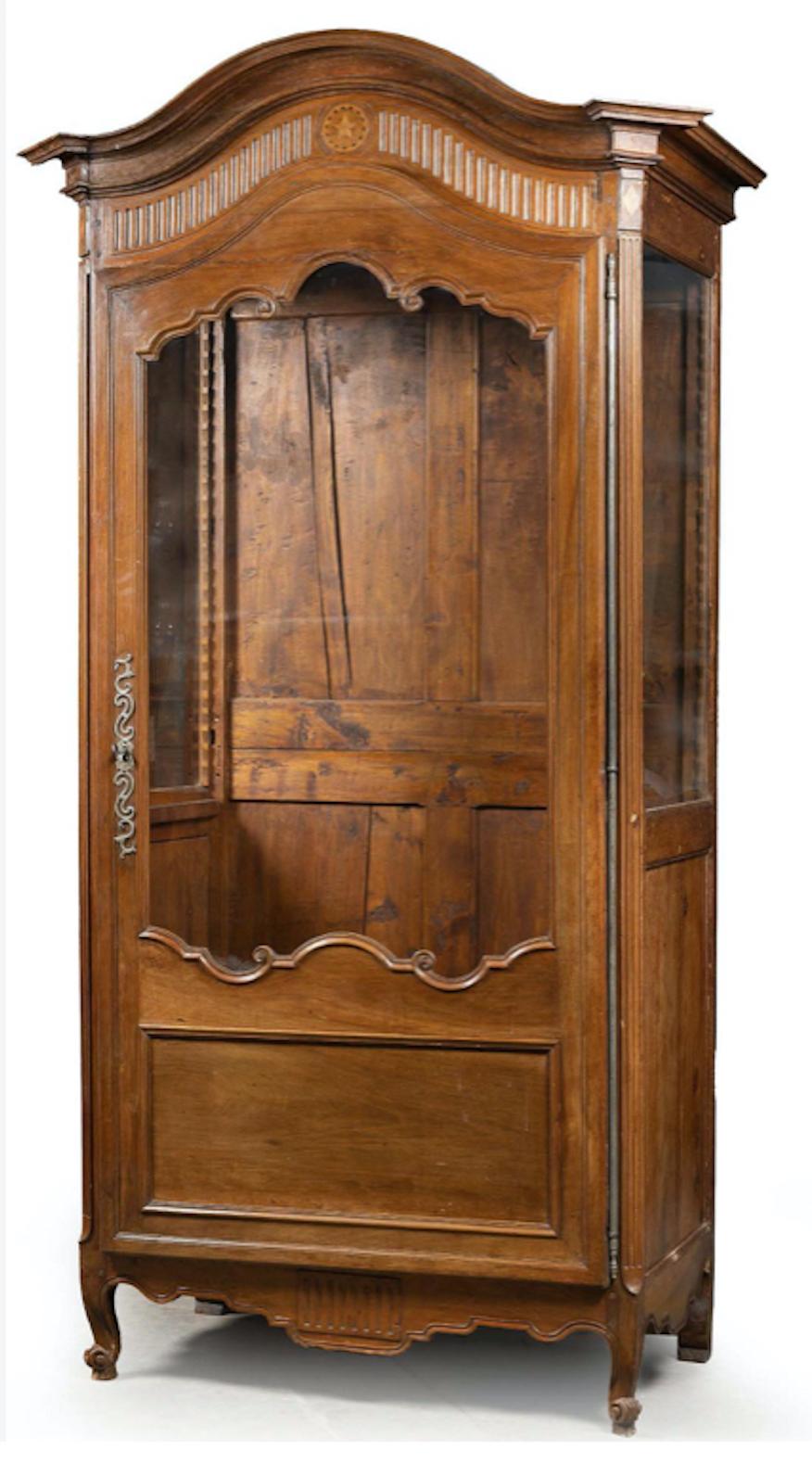 19th Century French grand vitrine or wardrobe made in fine hand carved walnut wood in provincial style. Very good and stable condition with no restorations made so far. Original glass door and glass sides.
France, circa 1860