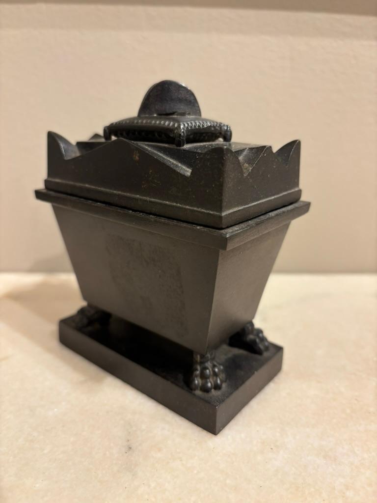 A mid 19th century Grand Tour, French, Inkwell in the form of Napoleon’s tomb. The patinated black iron tomb with removable lid revealing a sand sifter and inkpot. The interior with concealed effigy of Napoleon! The base with hairy paw feet and