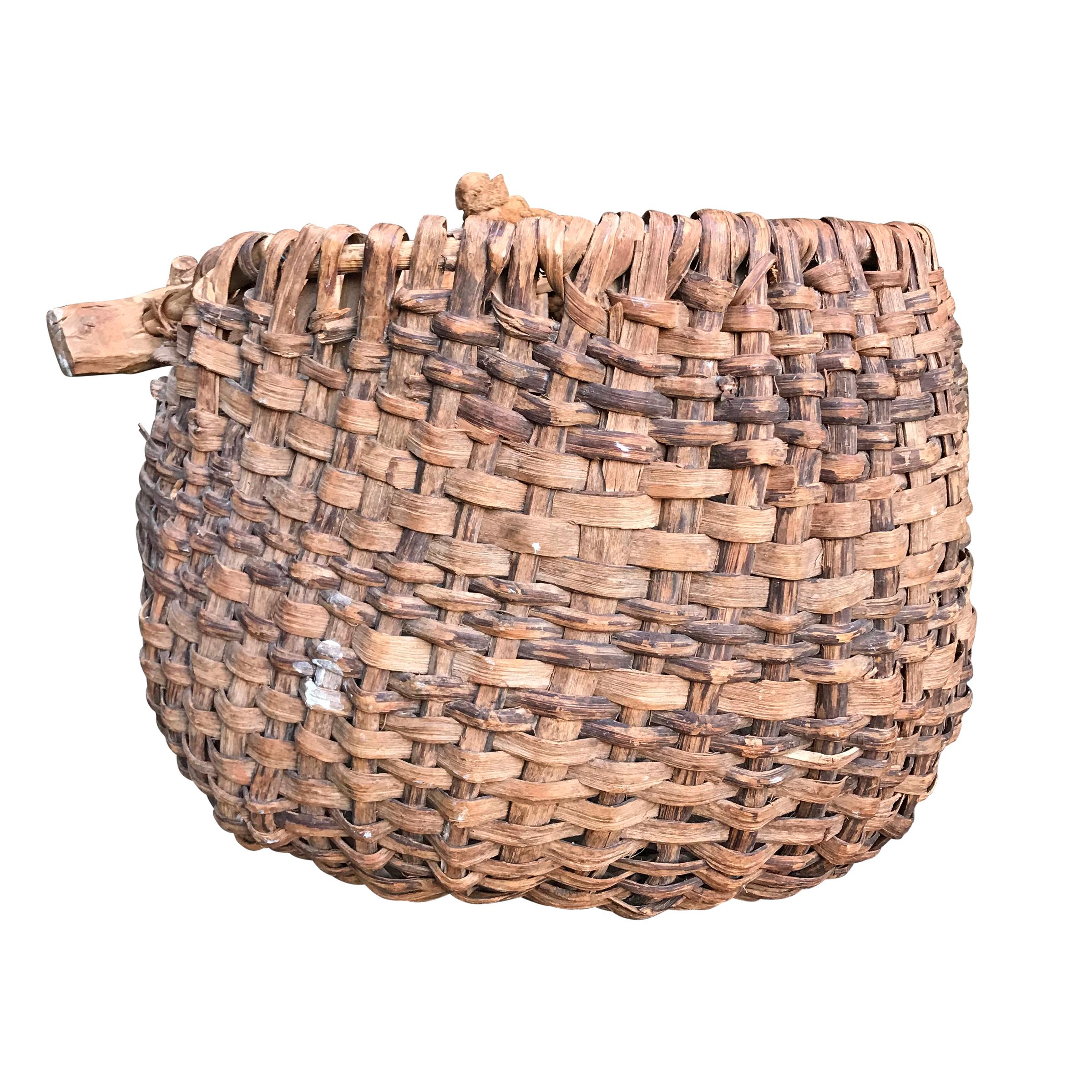 A beautiful 19th century French handwoven split wood grape gathering basket from a vineyard constructed with a large wooden crosspiece supporting two hoops, one forming the back, and one forming the lip of the basket. Wonderful form, and fantastic