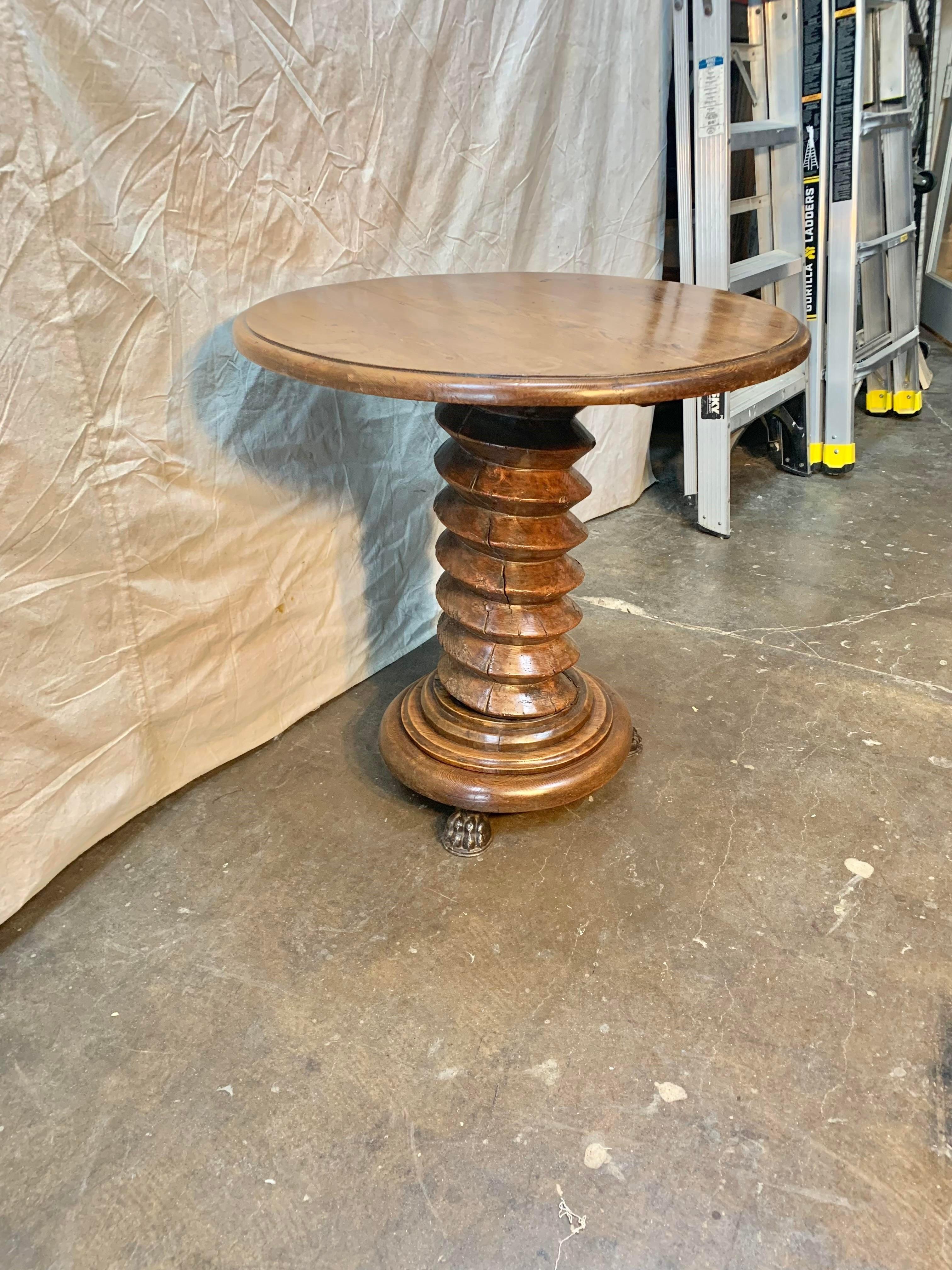 Made in France this 19th Century French Grape Press Pedestal Table is the perfect side table for the wine connoisseur. The table features a pine top which rests upon a walnut grape press base with cast iron claw feet. This wonderfully aged 19th