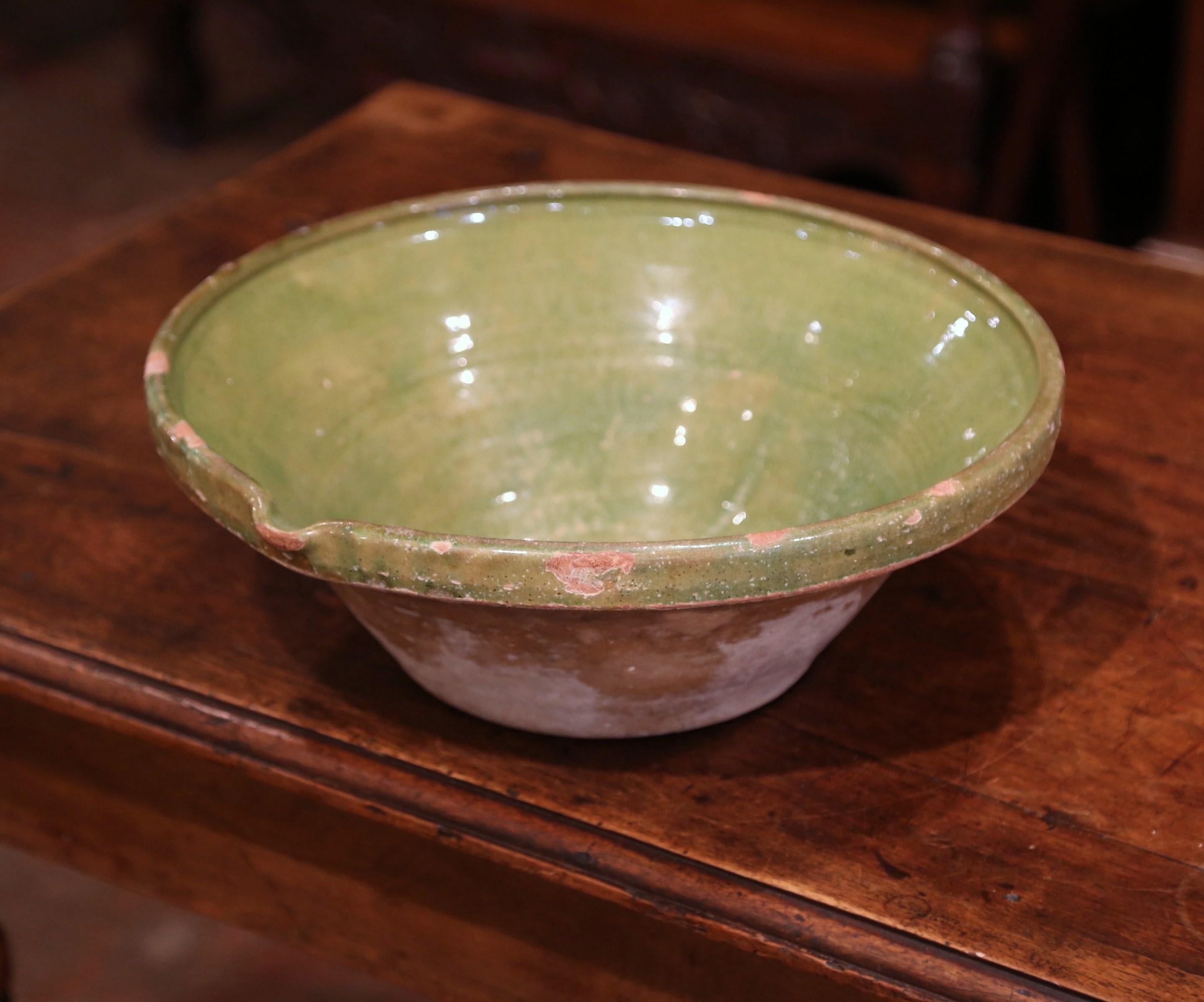 This beautiful antique Tian (Provencal term for bowl) was crafted in southern France, circa 1870; the round handmade terracotta decorative bowl features a server beak, and has a subtle green glaze on the inside with natural earthenware finish on the