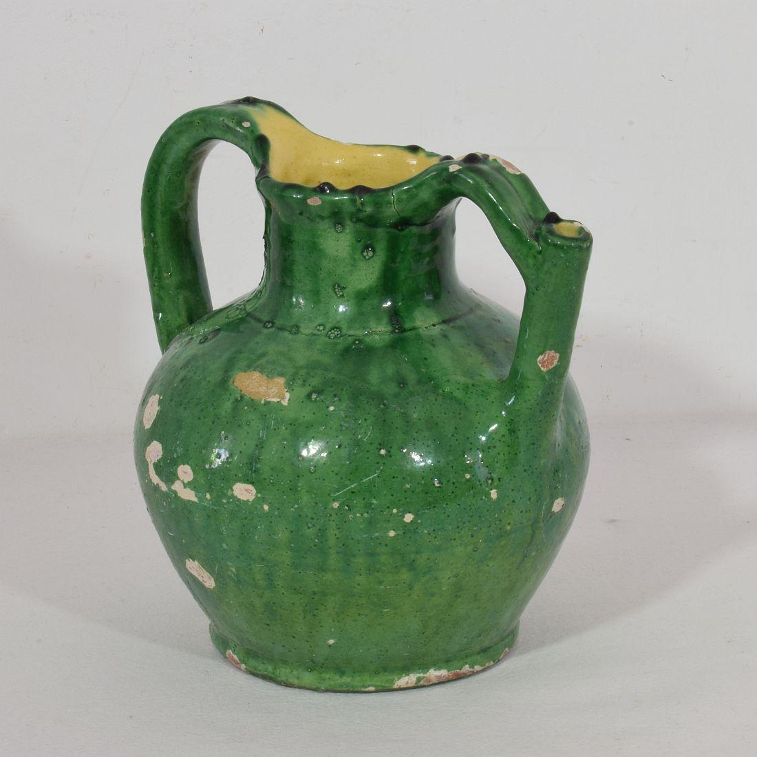 Great authentic and rare piece of pottery with a spout in handle from the Provence. Beautiful weathered and an amazing color. Imperfections help authenticate this water cruche as it was a utilitarian type piece, France, circa 1850.