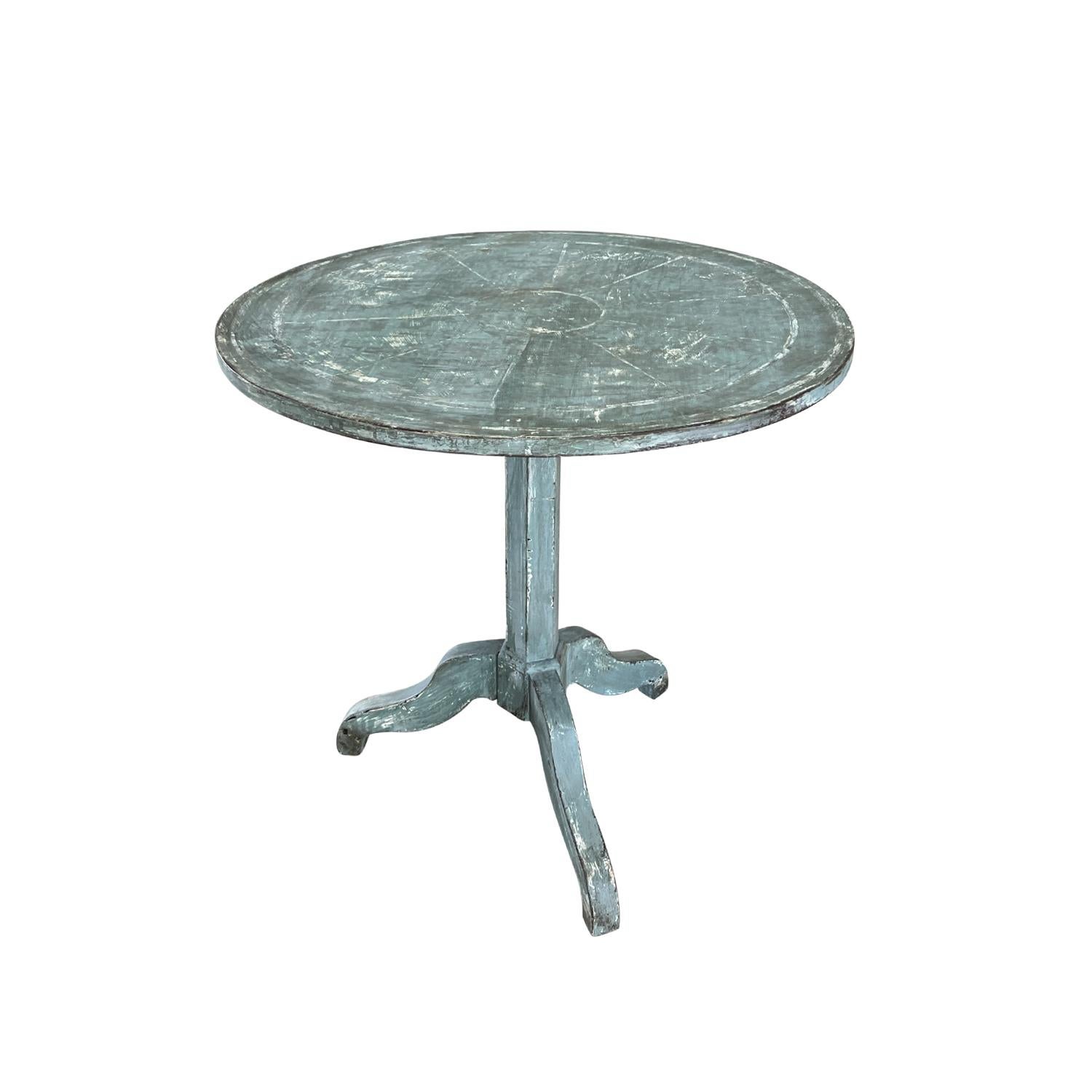 An original, antique French Gueridon table from the Napoleon III period. The round top is made of hand crafted painted Pinewood and the chassis is a tripod. In original condition with visible wear and heavy patina. Wear consistent with age and use.