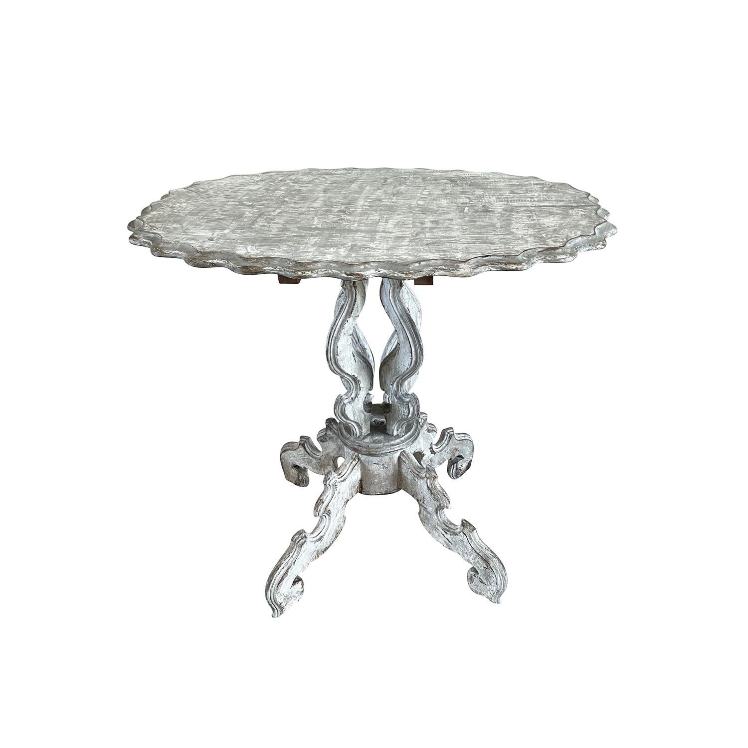 An original, antique French Gueridon table from the Napoleon III period. The painted Pinewood side table has a very decorative scalloped edge and elegantly carved base with four legs. In original condition with visible wear and heavy patina. Wear