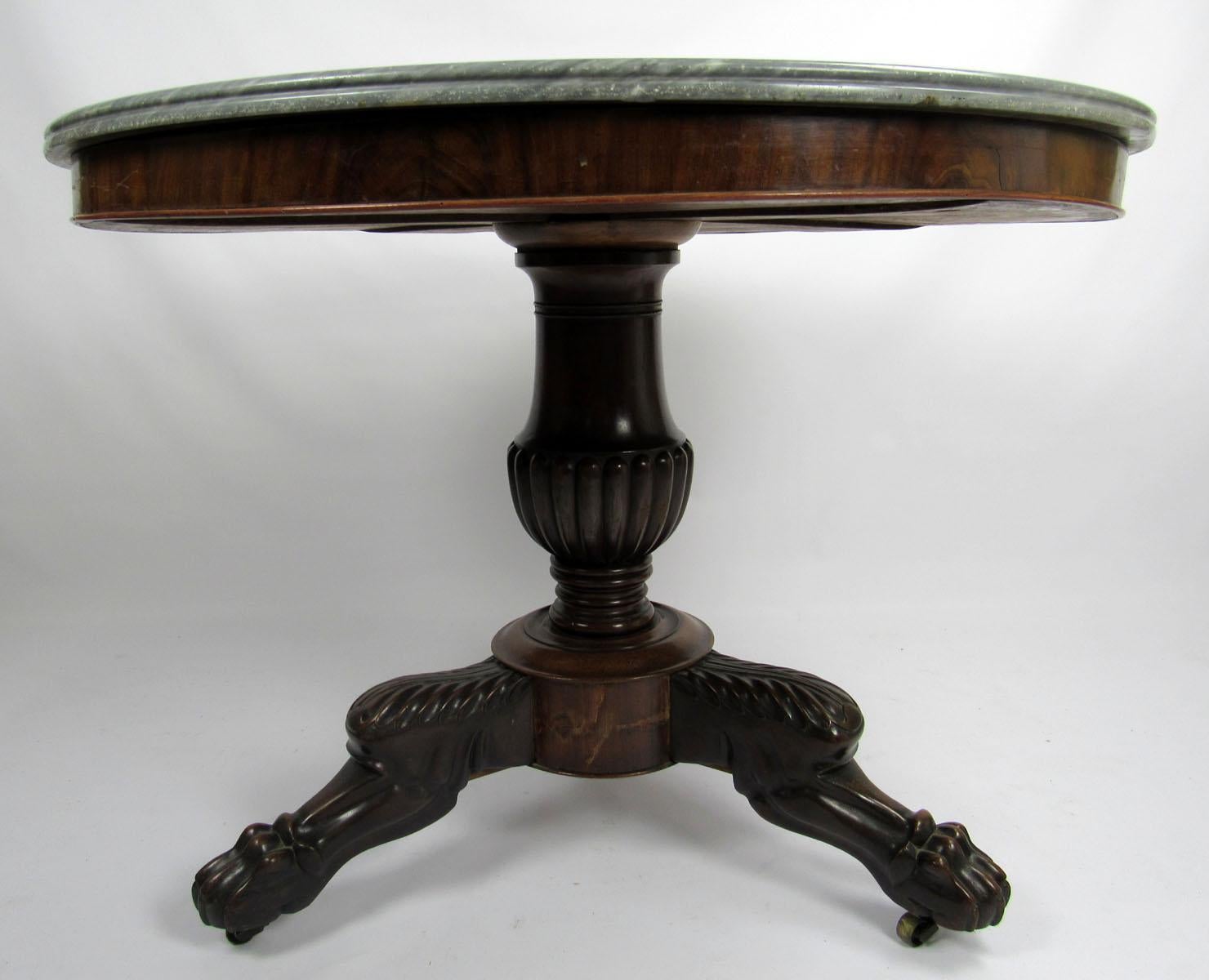 Restauration period, Bleu Turquin marble top gueridon table with carved griffon feet. Beautiful Bleu Turquin marble is hand-cut and molded on the surface to create a natural border