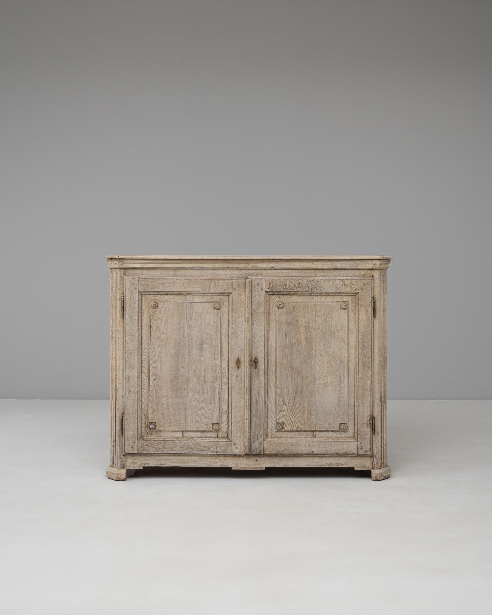 This 19th-century French Gustavian buffet is crafted from solid oak and showcases the refined simplicity characteristic of the Swedish-inspired Gustavian style. The bleached finish highlights the natural wood grain, giving the piece a soft,