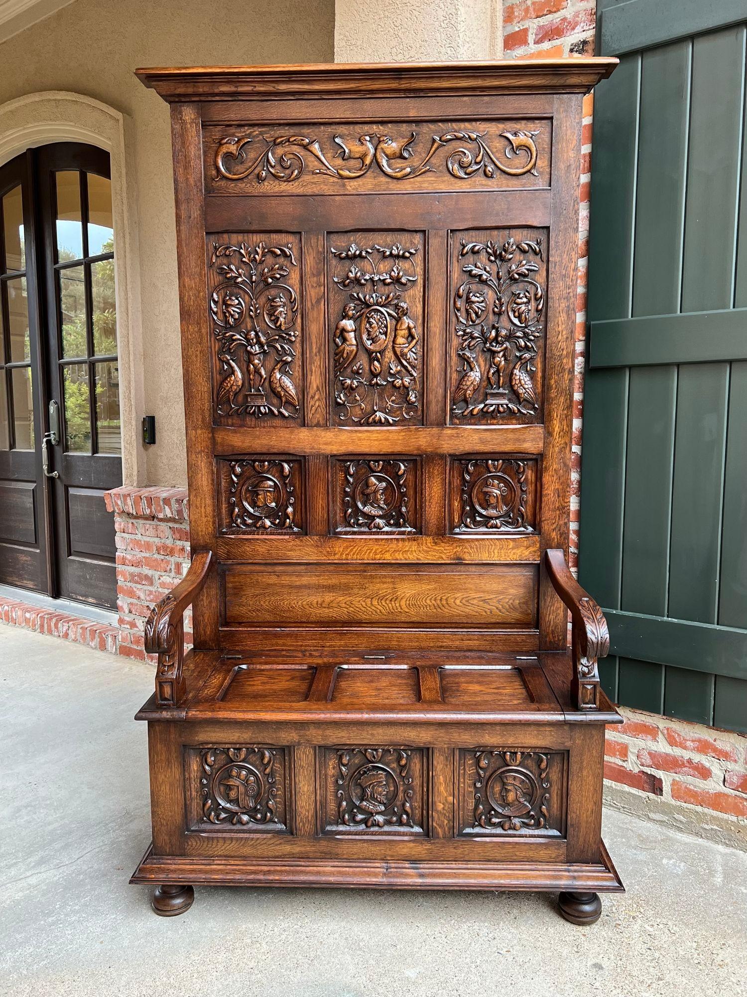 19th century French hall bench settle renaissance carved oak Breton Brittany.

Direct from France, a massive antique French hall bench, large enough for any home or castle! The 6.5 ft. back features an upper panel of mythic creatures above three